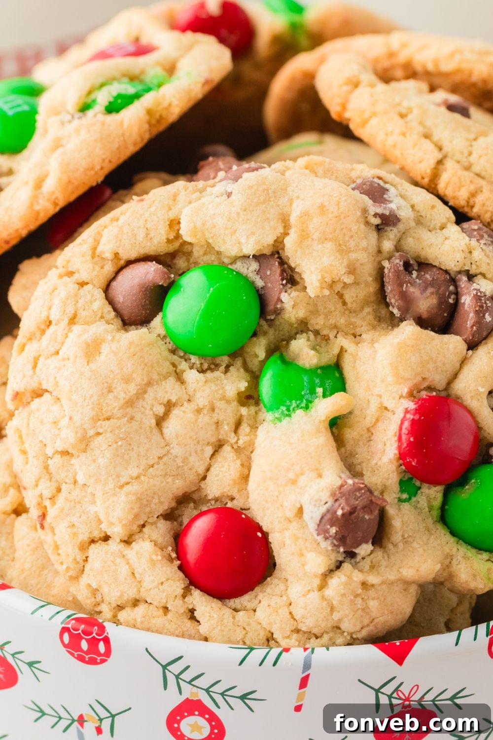 Festive M&M Delights 17 Close-up view of Christmas M&M cookies stored in a festive tin, ready for gifting or enjoying, emphasizing their colorful appearance