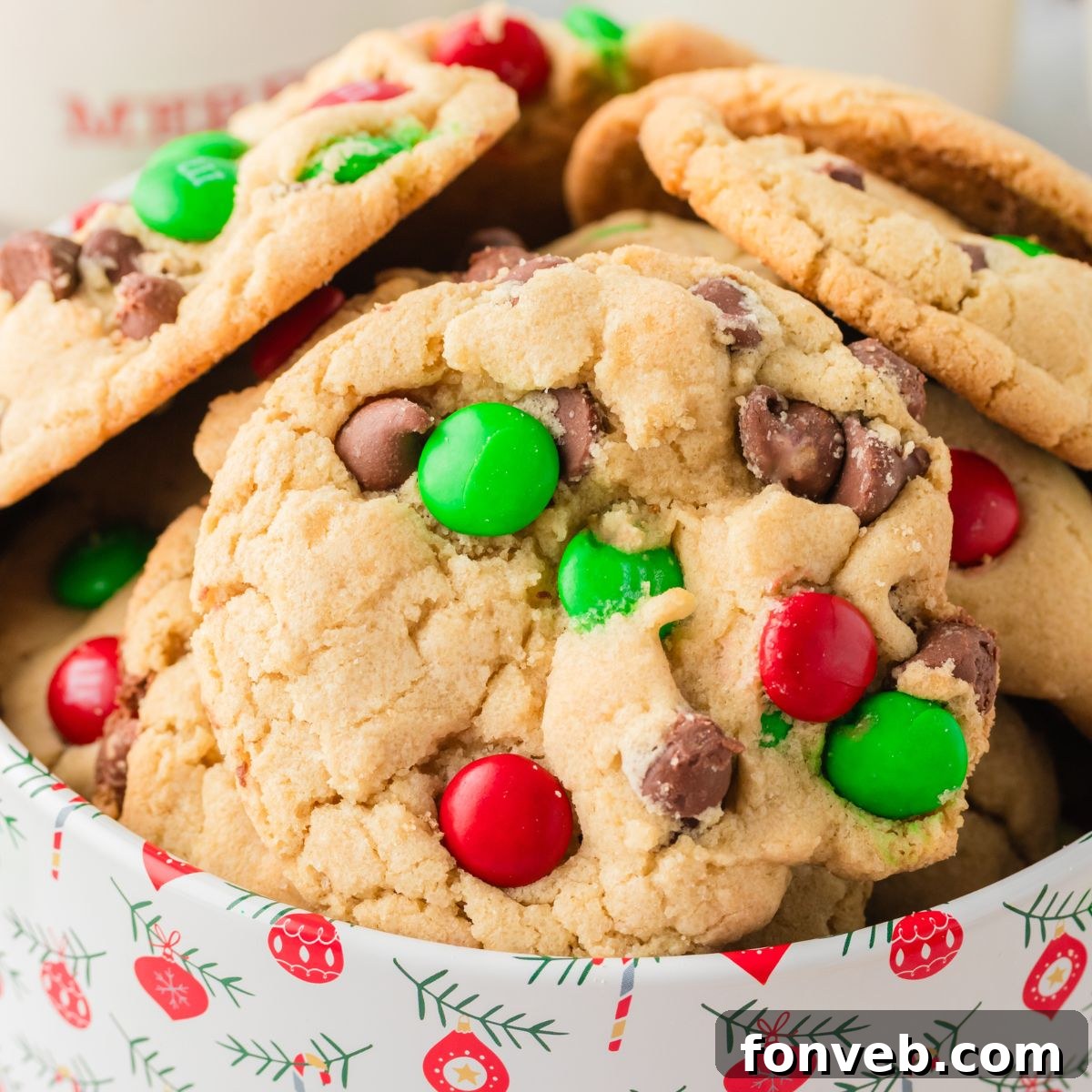 Festive M&M Delights 3 Festive Christmas M&M Cookies neatly arranged in a decorative tin, ready for gifting