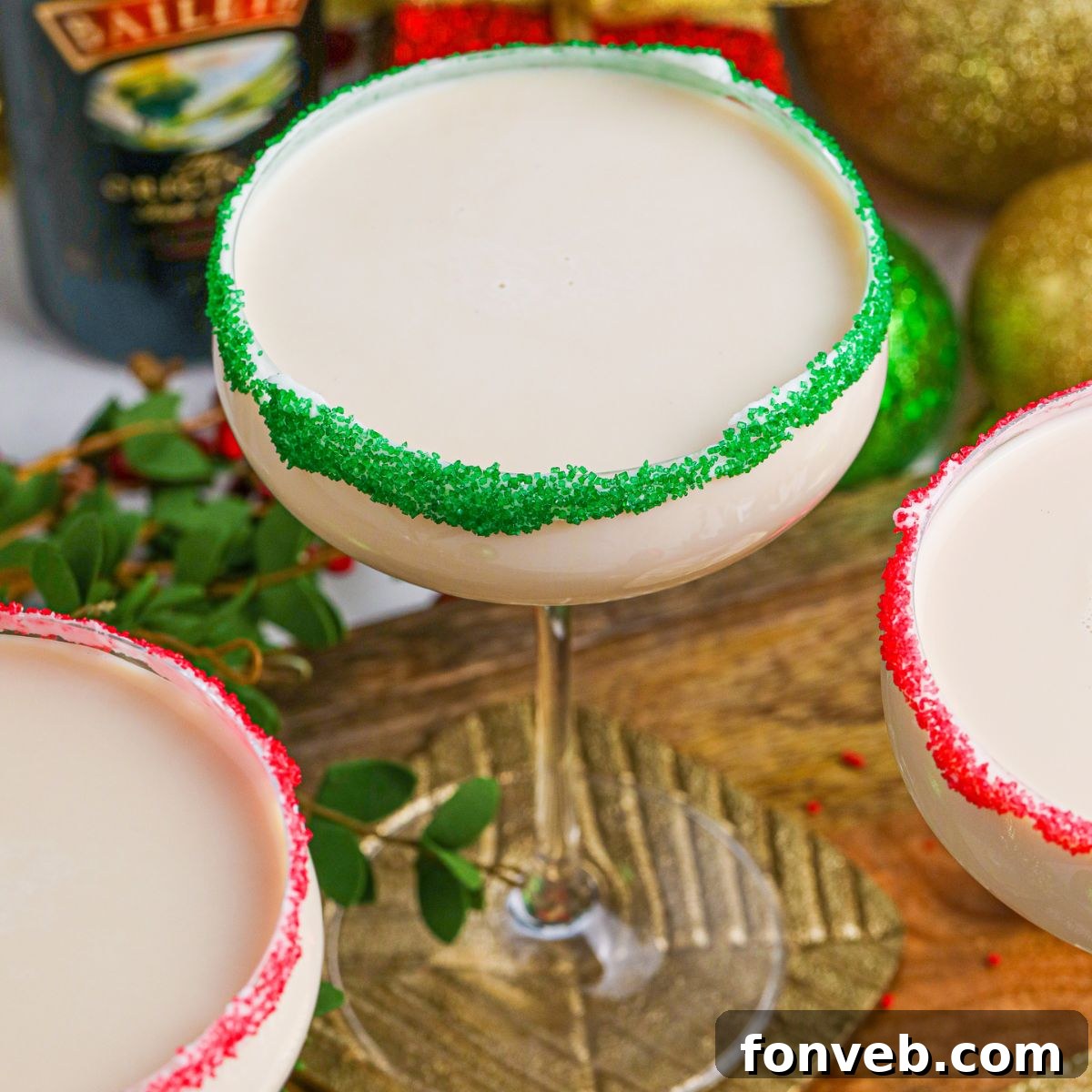 Overhead view of two Sugar Cookie Cocktails with colorful sugar rims, meticulously arranged on a wooden table, emphasizing their festive appeal.