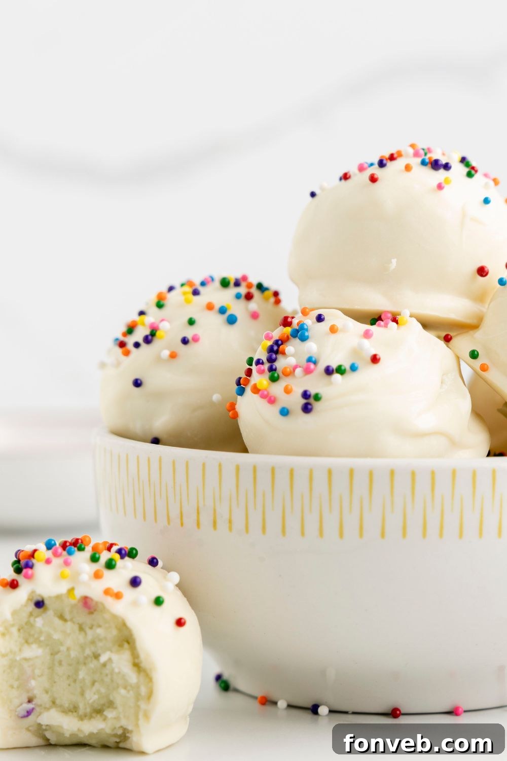 bite taken out of a cake ball on a bowl