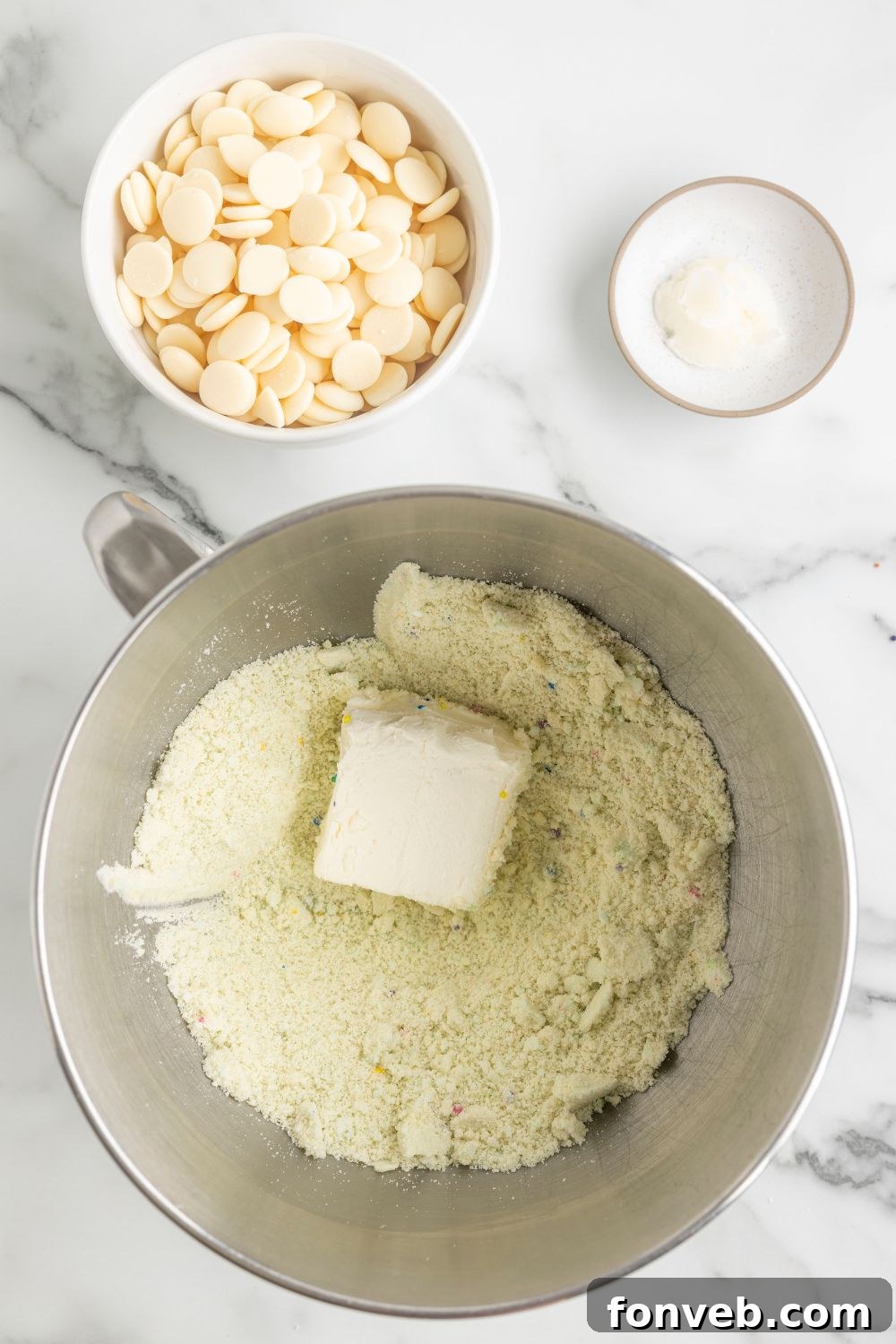 cream cheese in a bowl with sugar cookie dough 
