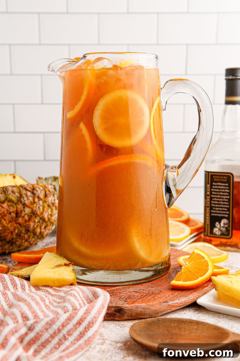 Endzone Chill 12 Touchdown Tea in a pitcher on a table, surrounded by the fruits used in the drink.