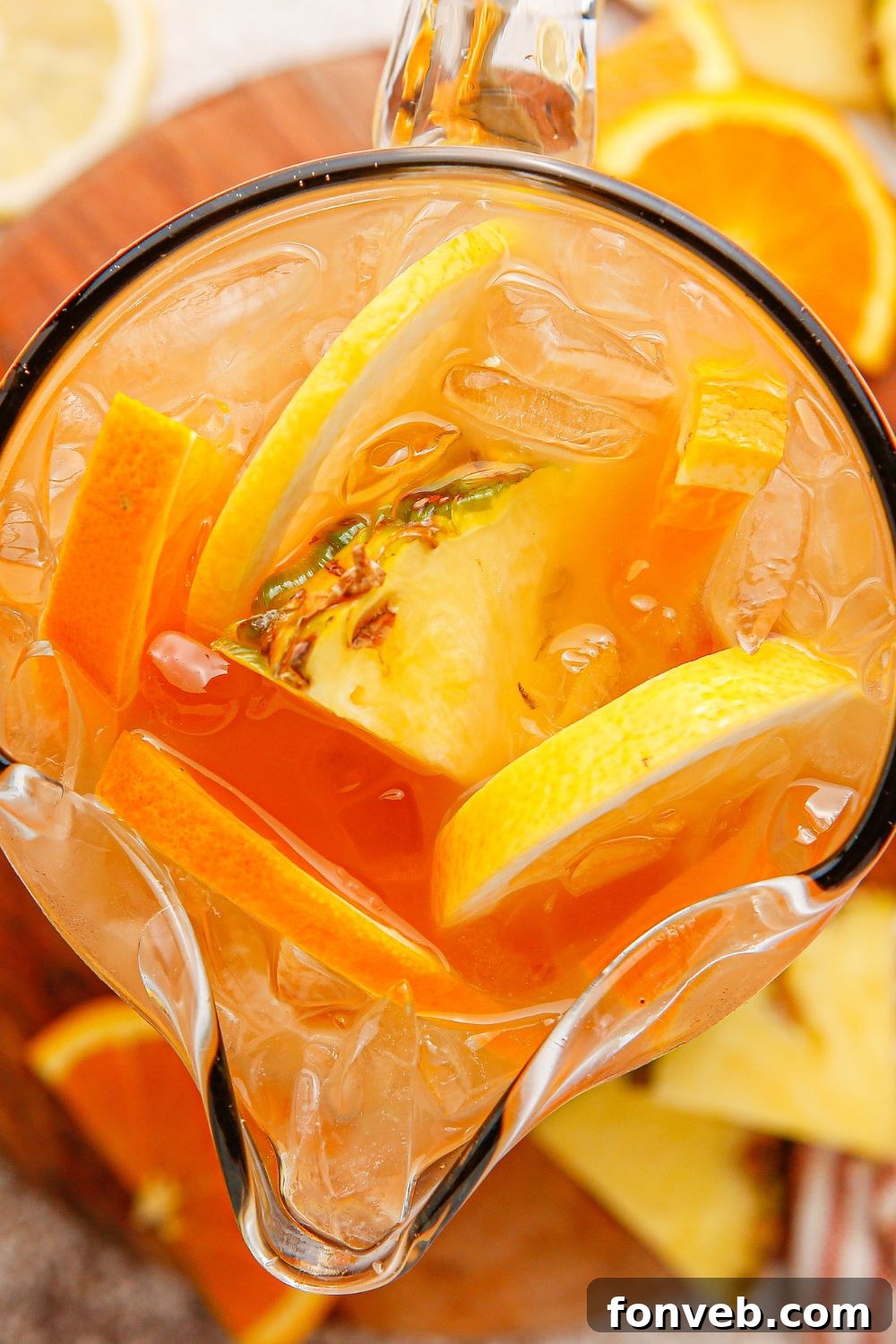 Endzone Chill 10 Sweet tea bourbon in a glass serving container with sliced fruit around it.