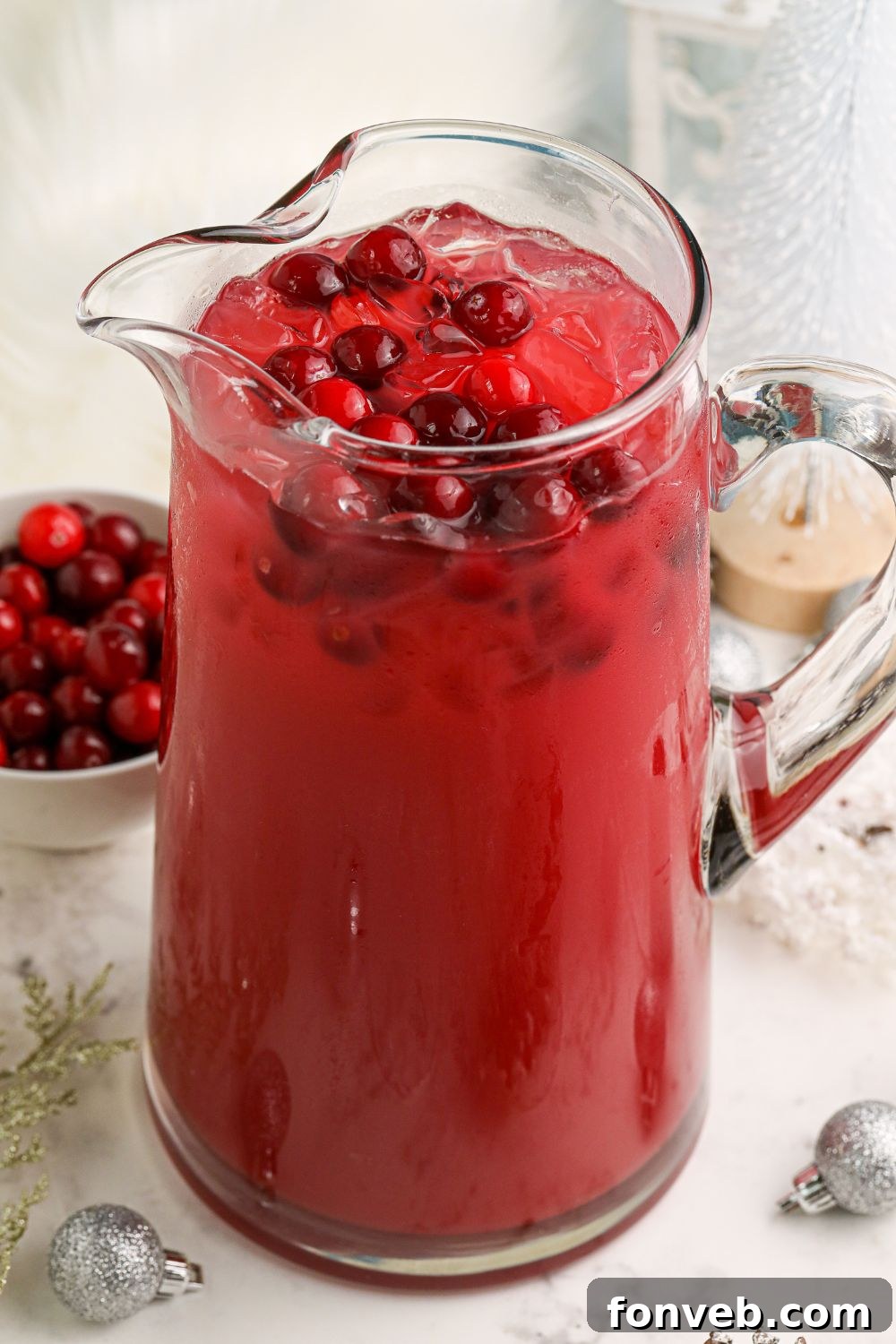Mistletoe Magic Margarita 11 Mistletoe Margarita mixture in a pitcher, topped with fresh cranberries.