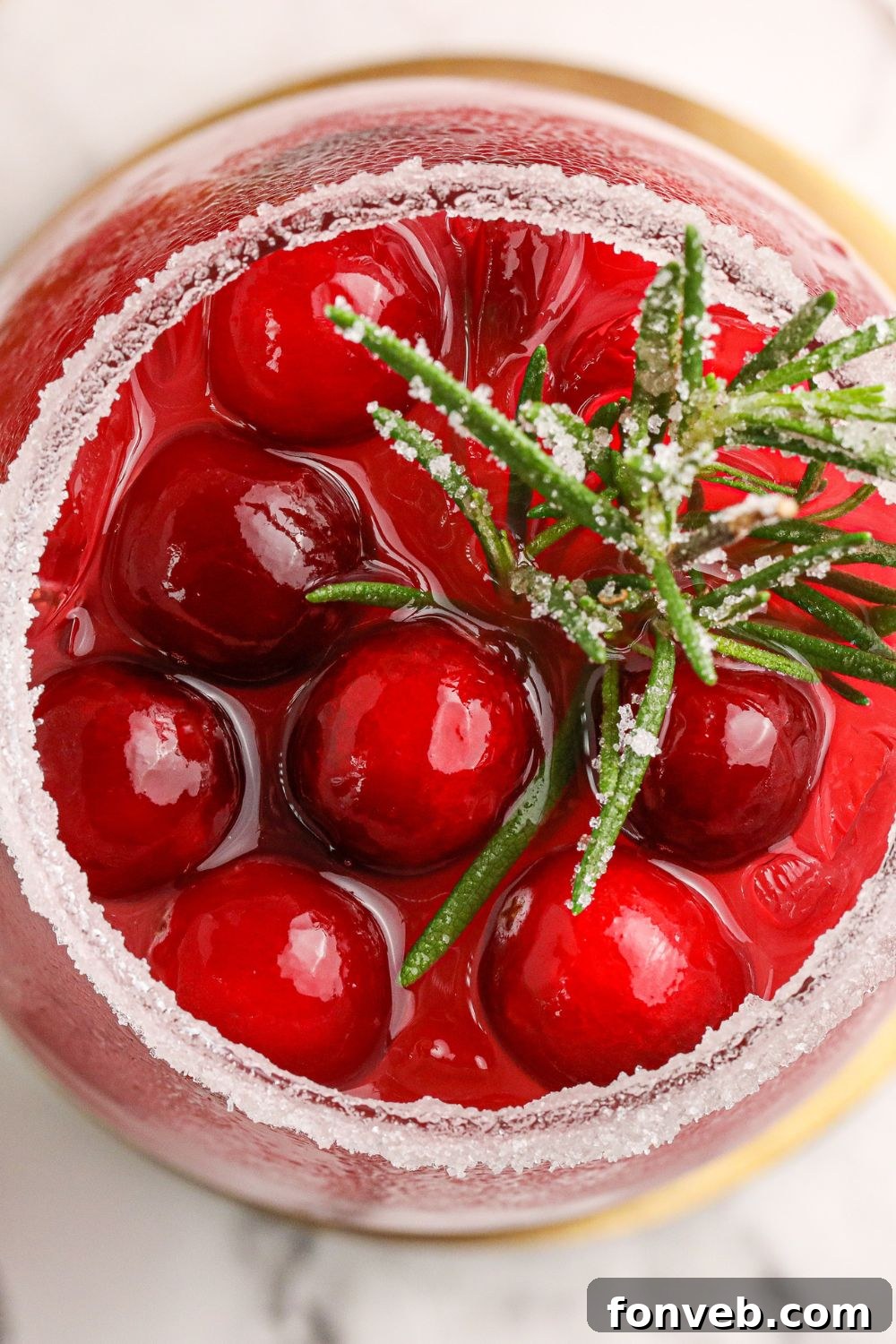 Mistletoe Magic Margarita 5 An overhead shot of a Mistletoe Margarita, beautifully garnished with cranberries and rosemary.