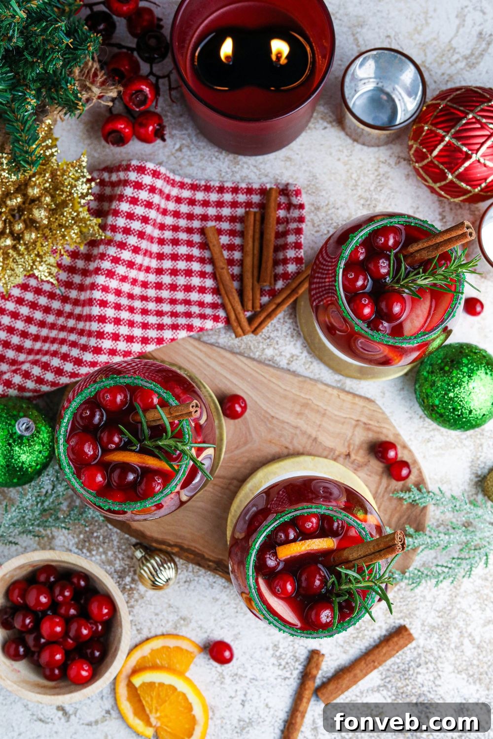 Christmas Sangria in glasses and garnishes all around it for presentation 