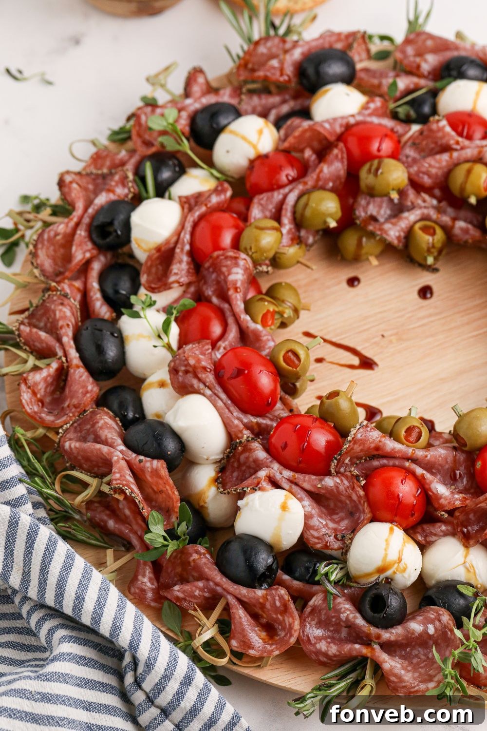 Christmas wreath shaped appetizer on a rustic wooden table with decorative elements