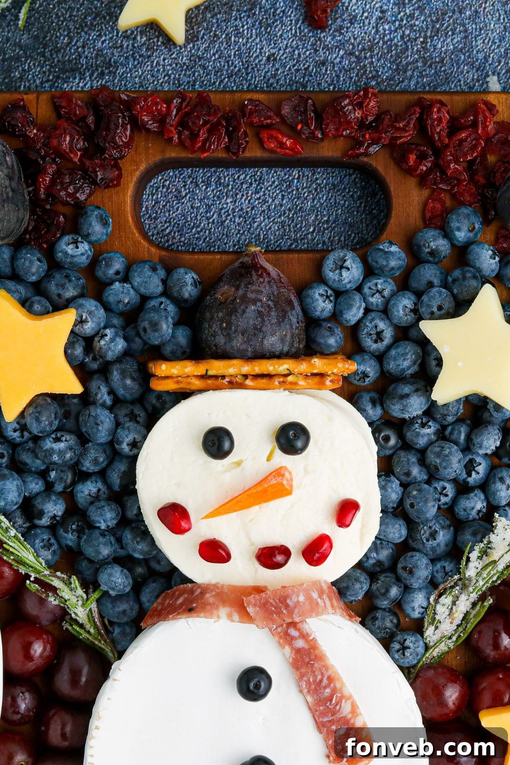 Top-down view of the snowman snack board, showcasing its artistic arrangement and rich colors
