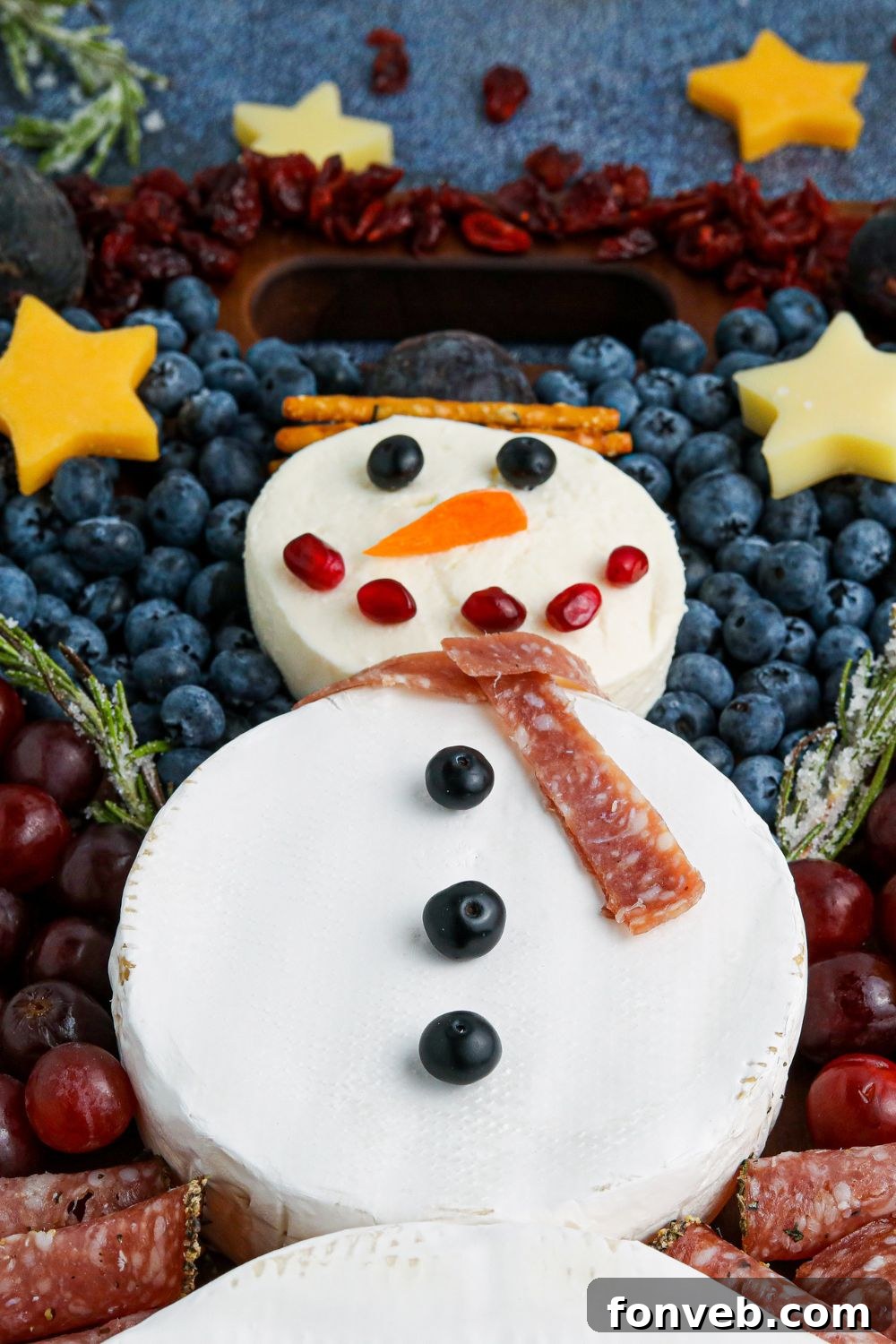 Snowman Charcuterie Board side view, highlighting the depth and variety of ingredients on a wooden tray
