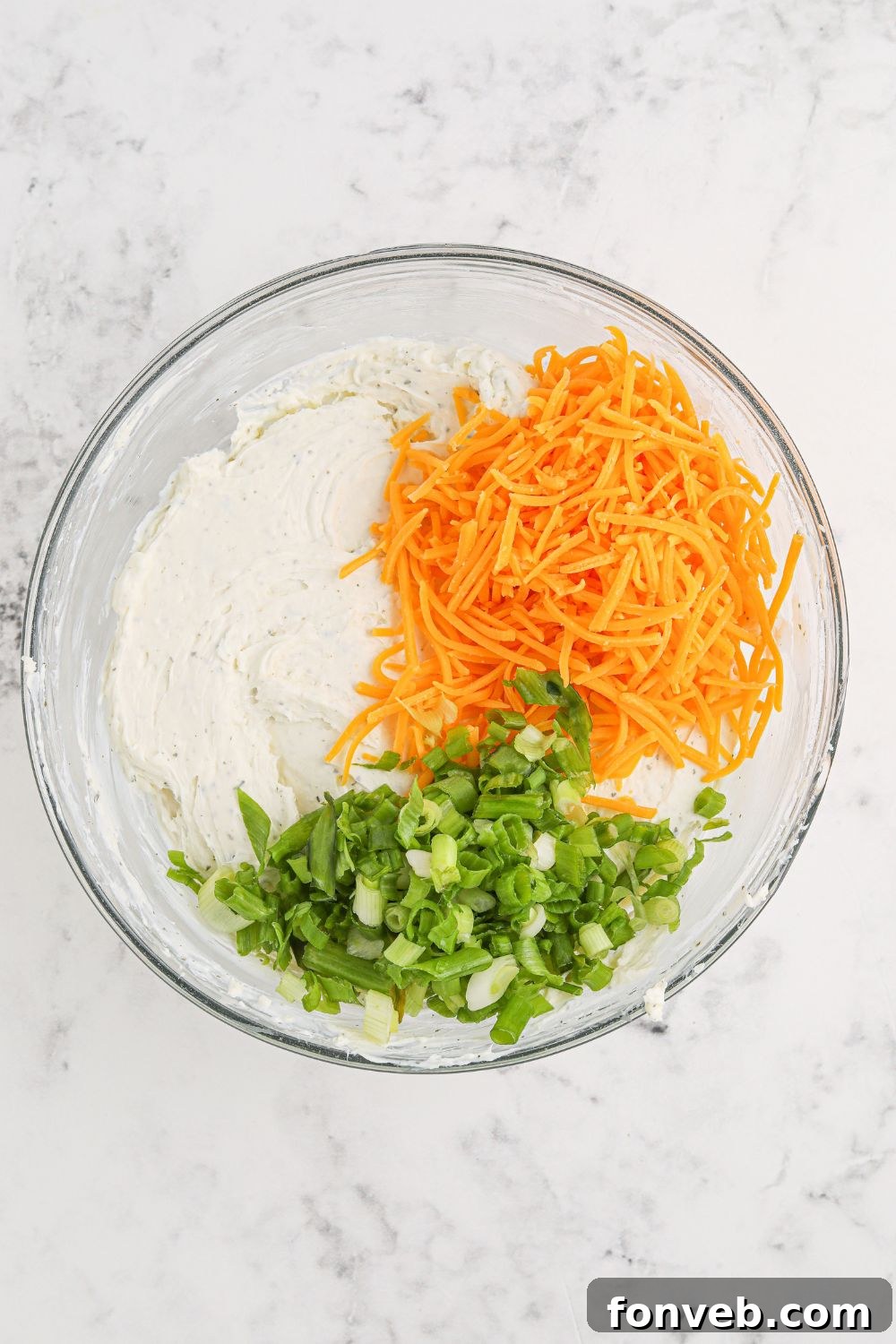 Rudolph's Holiday Charcuterie Platter 5 Ingredients for cheeseball being mixed in a bowl