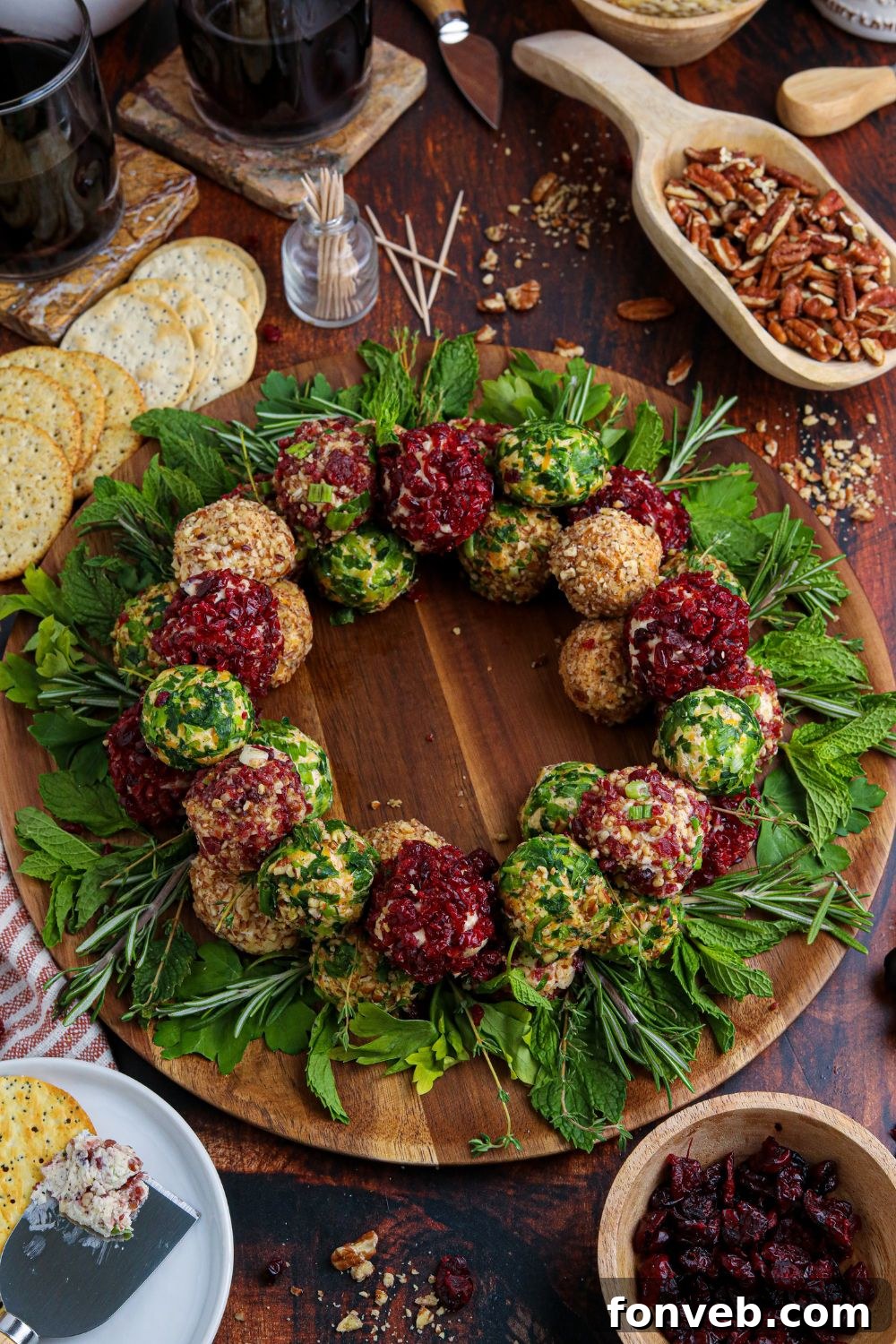 Close-up of mini Christmas cheese balls meticulously arranged on a round cutting board, showcasing their festive coatings.