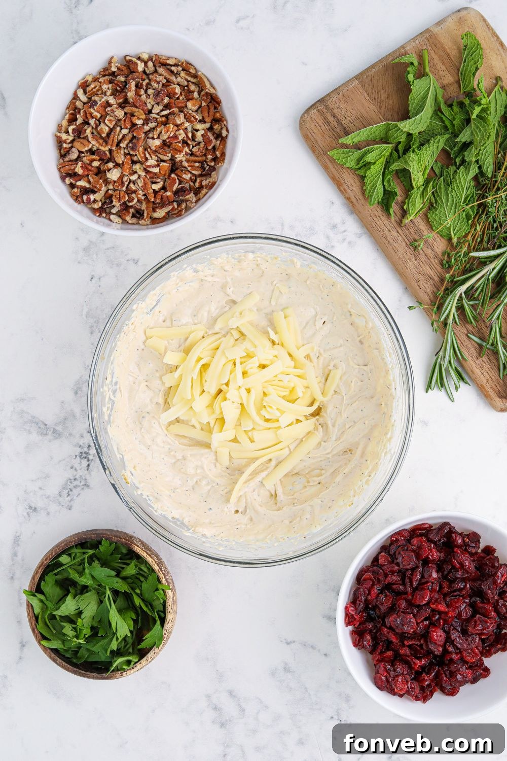 A bowl containing the zesty herb cheese ball mixture, showcasing its green specks of chives.