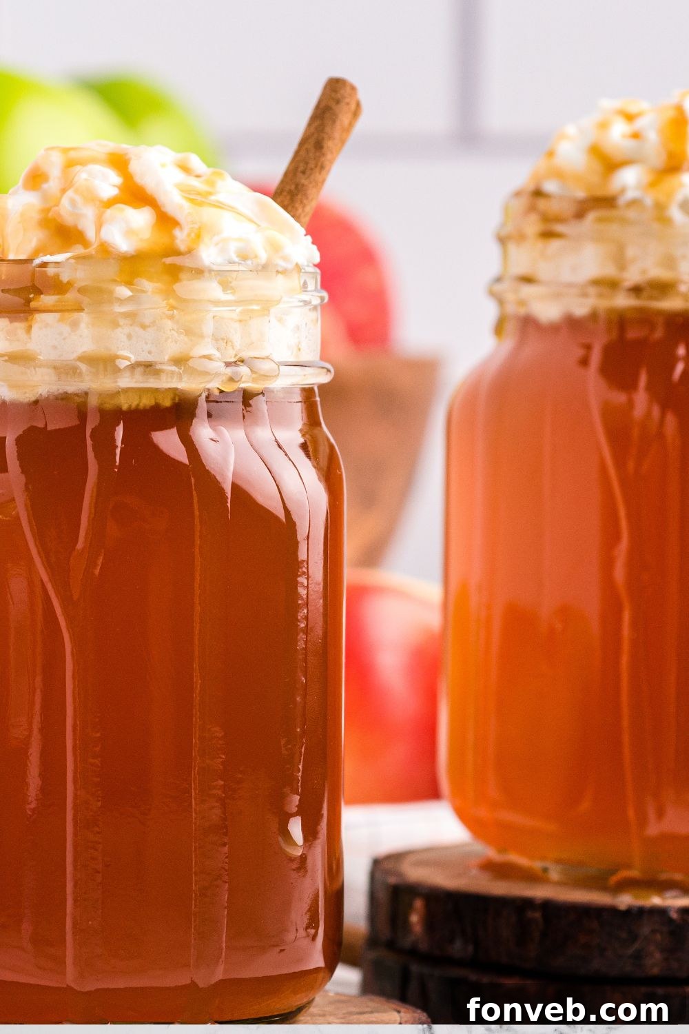Cozy Caramel Apple Brew 14 Two mugs, reminiscent of Starbucks caramel apple cider, on a wooden table, evoking a cozy café feel.