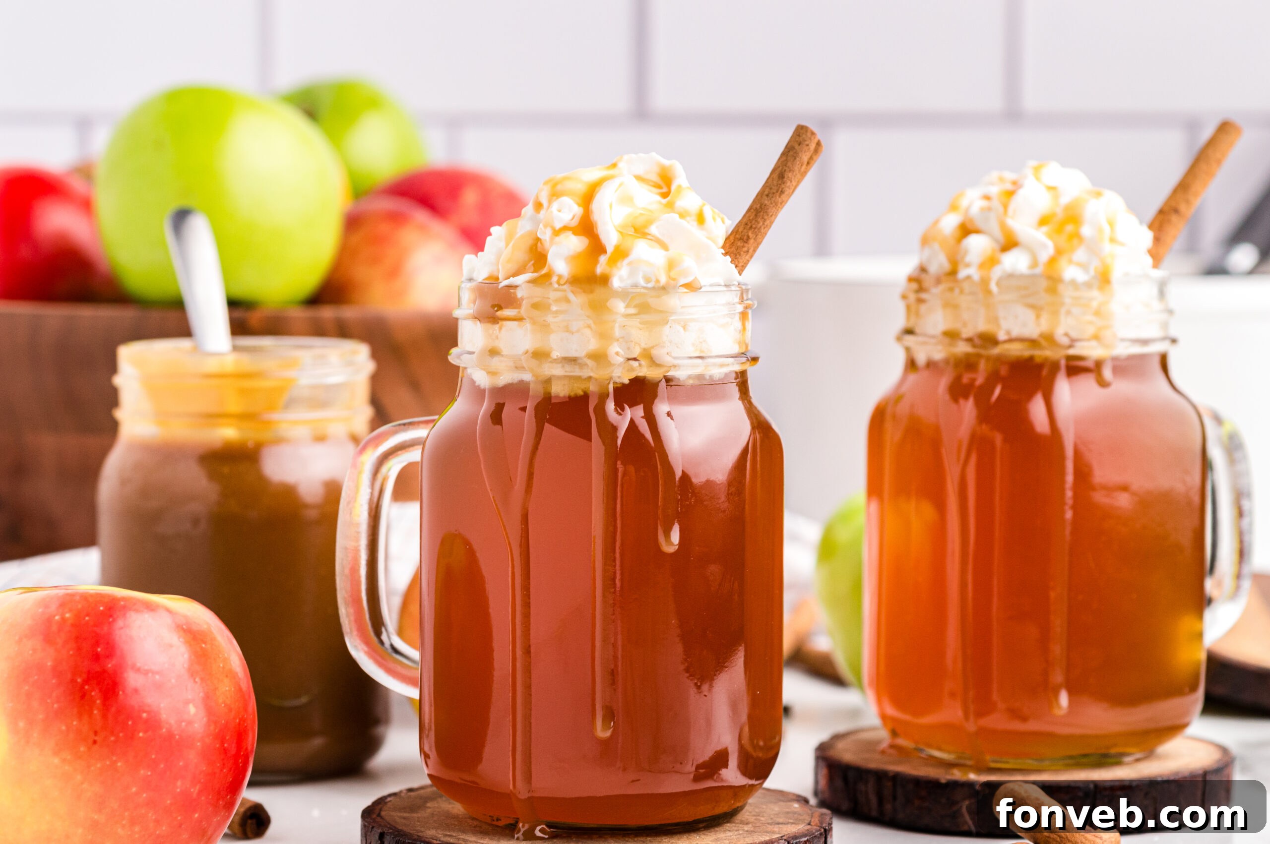 Cozy Caramel Apple Brew 17 Two mugs, styled like Starbucks caramel apple cider, sitting on a wooden table, emphasizing the copycat nature of the recipe.