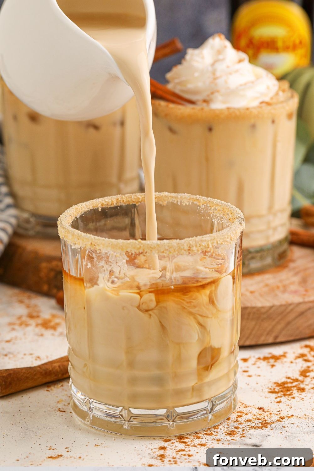 The process of adding Kahlua to the drink, highlighting the mix of spirits and flavors.