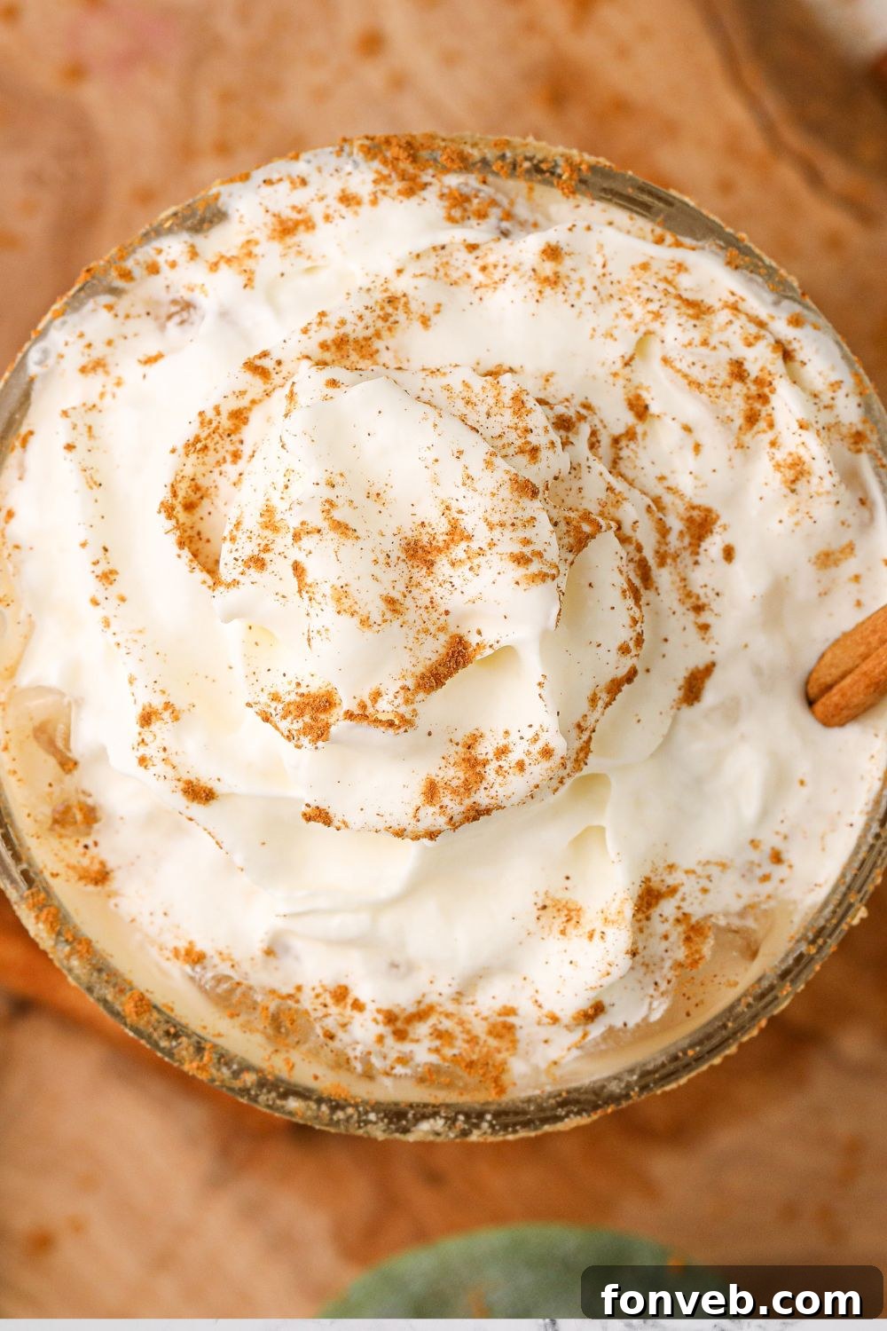 An overhead shot of a single pumpkin white russian cocktail, perfectly showcasing its layers and garnish.