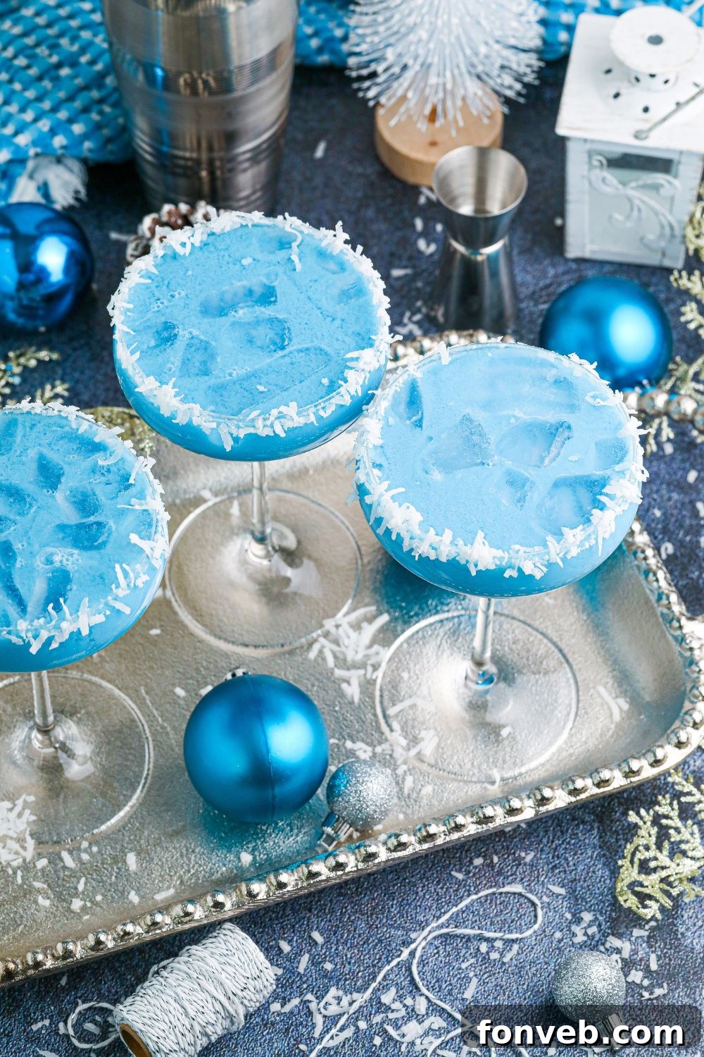 A collection of festive blue drinks artfully arranged on a table, ready to be enjoyed at a holiday gathering