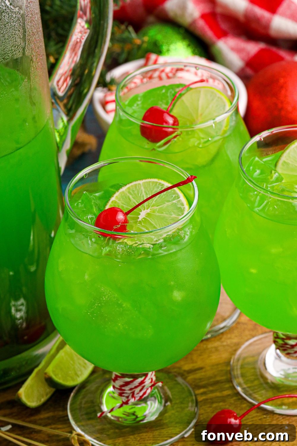 Lime flavored punch in glasses with lime wedge and cherries on top of glass 