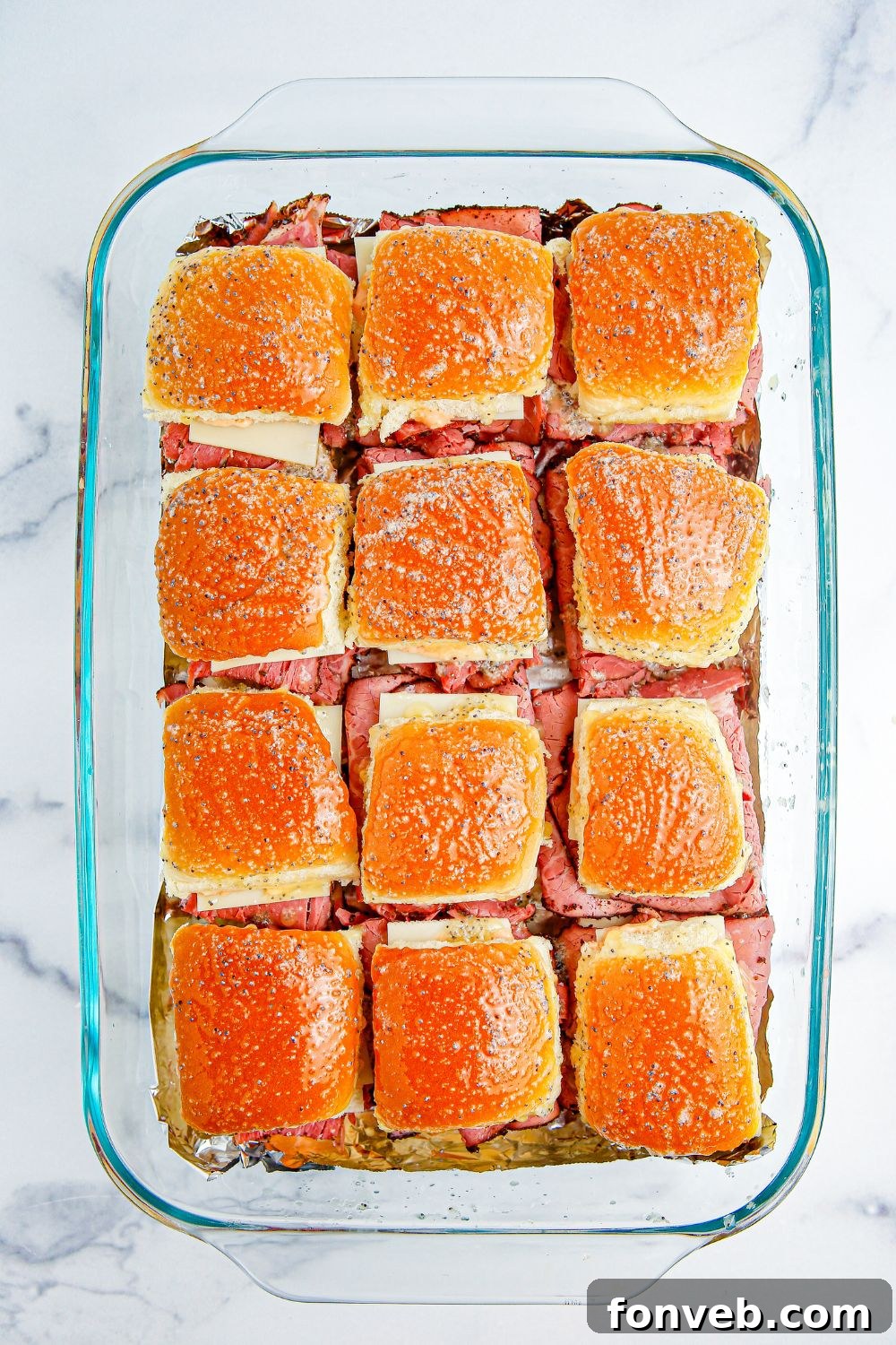 buttered sliders in a baking dish 