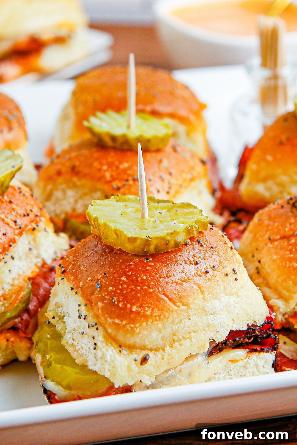 pan with sliders on it with a pickle on top