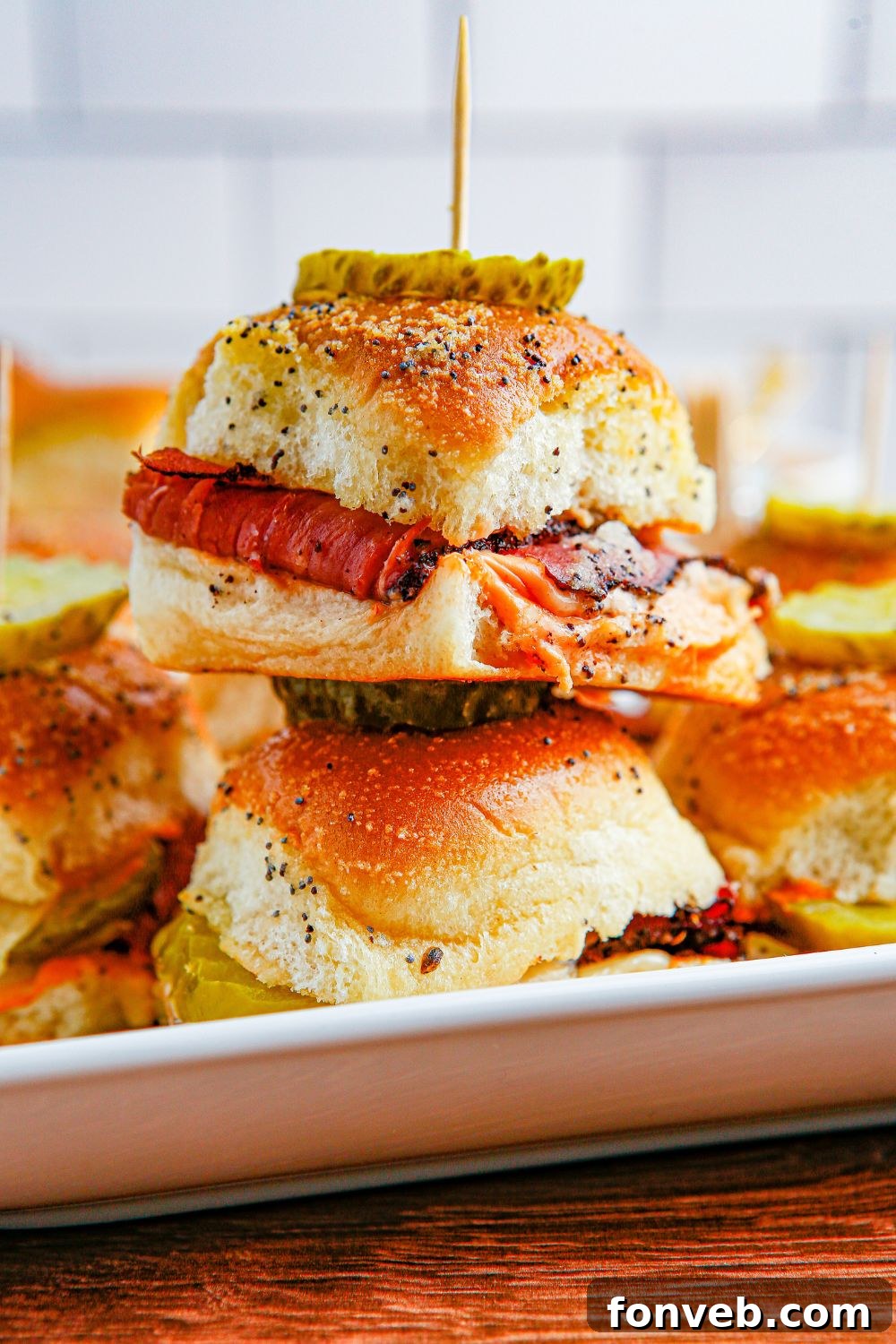 Pastrami Sliders on a white square platter on table 