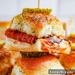 Pastrami Sliders stacked on table with toothpick in the center