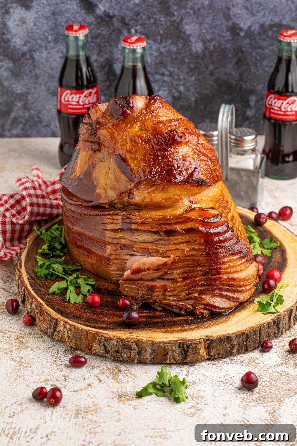 ham on a platter on table with coke bottles in the background