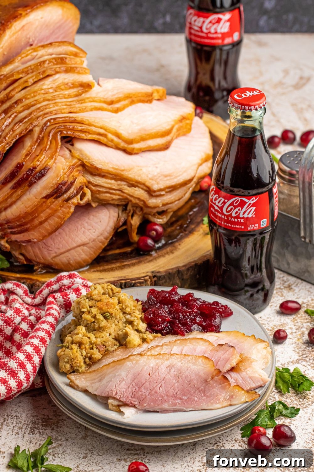 ham dinner on table with bottles of coke sitting by the rest on ham on platter