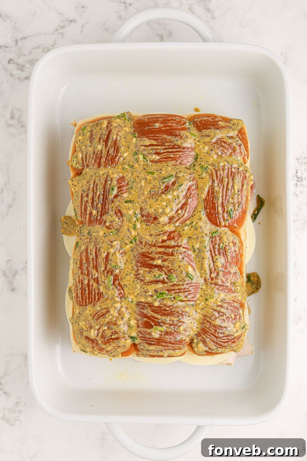 Close-up of buttery slider rolls brushed with the savory topping