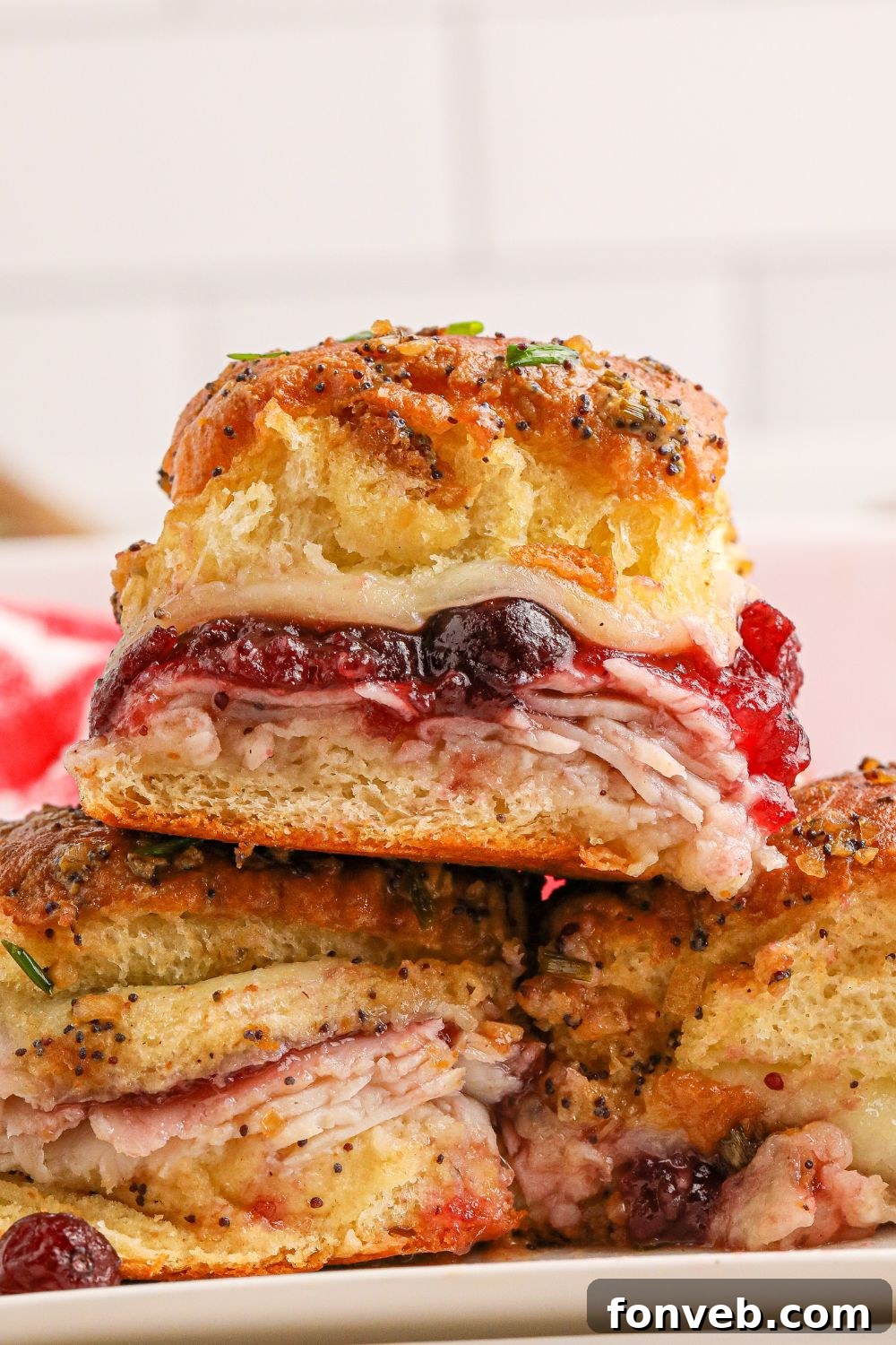 Close-up of turkey sandwiches with cranberries stacked on top of each other, highlighting the layers