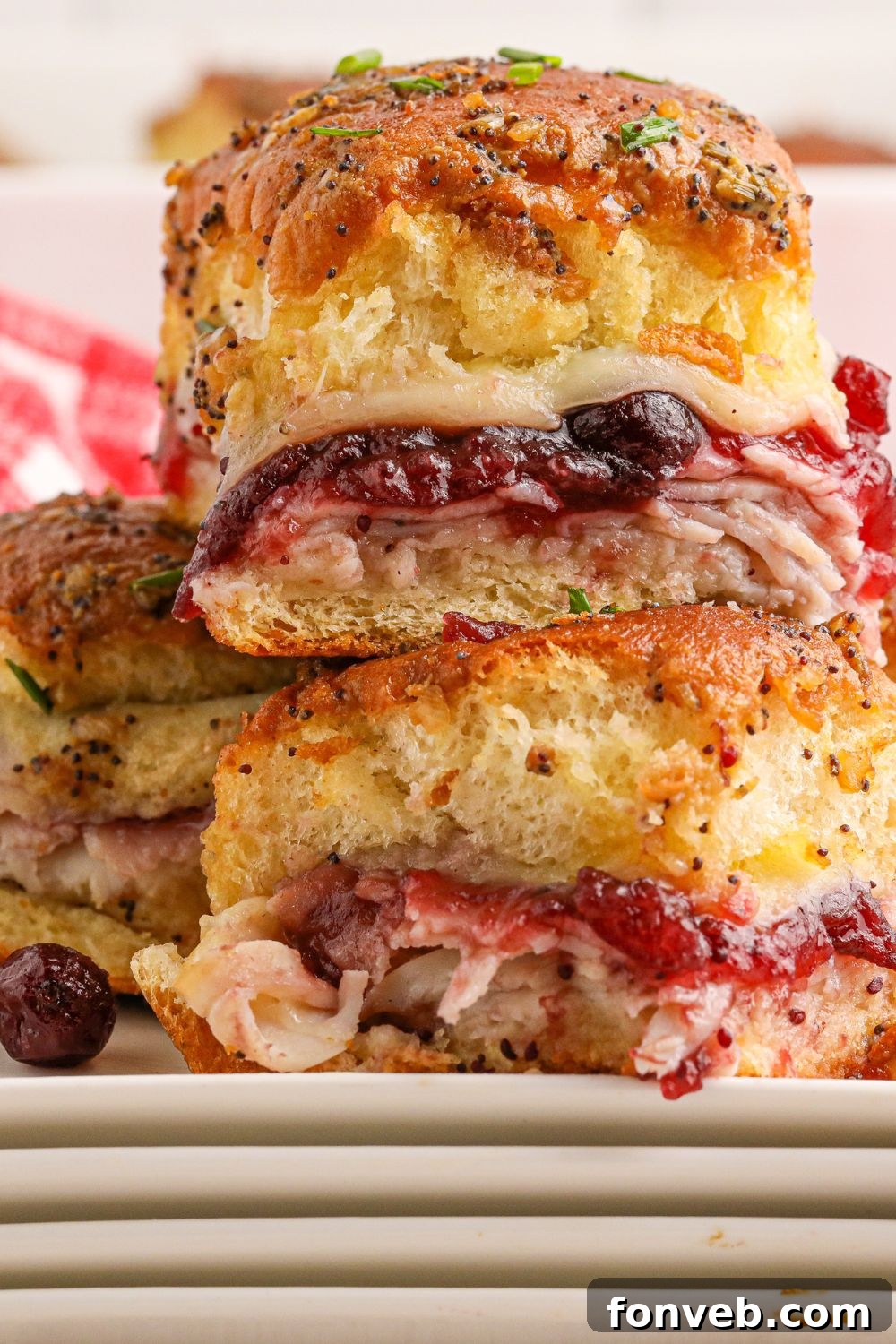 Thanksgiving sliders stacked on top of each other on a plate, ready to be enjoyed