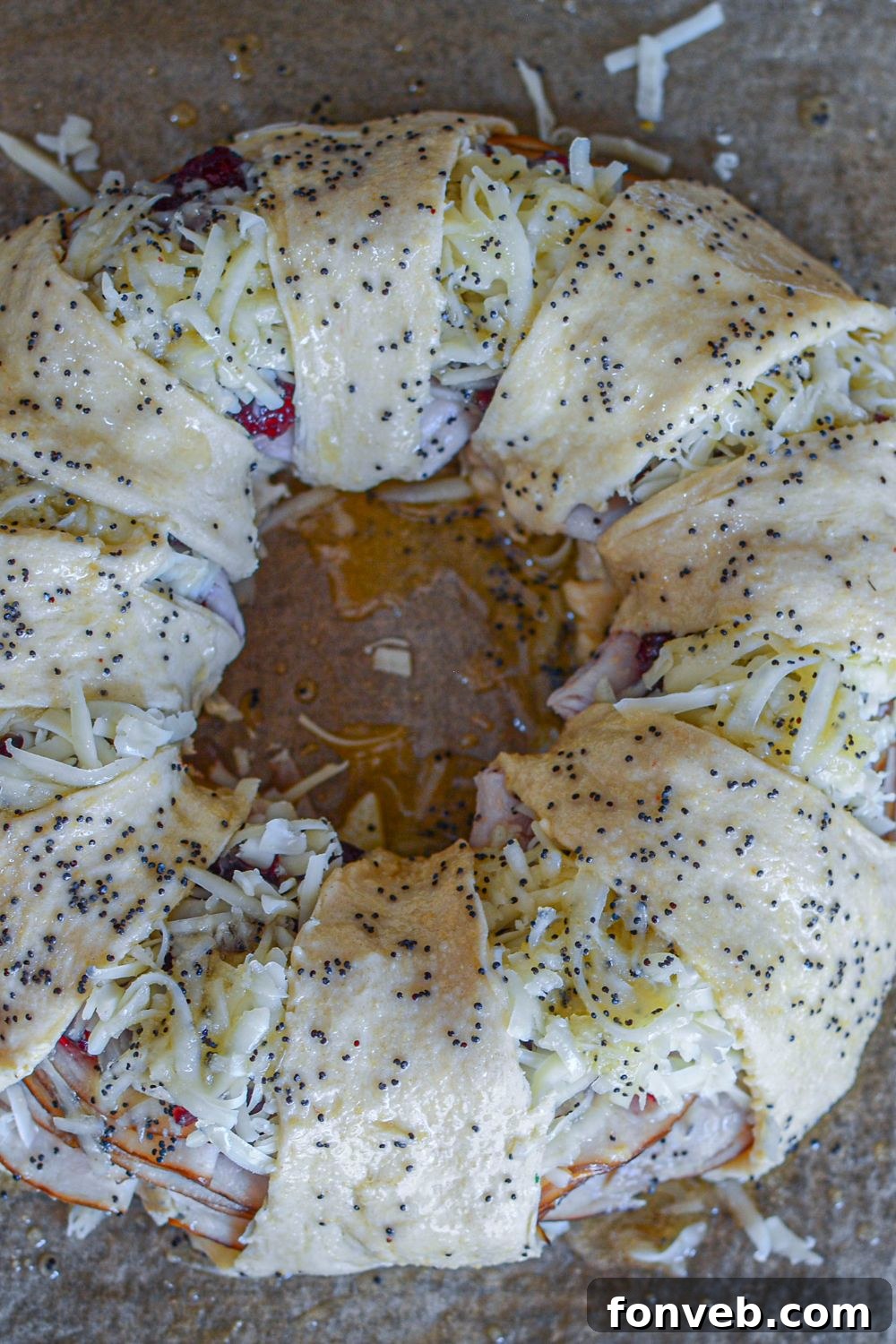 The fully assembled crescent roll ring on a baking sheet, ready for the oven
