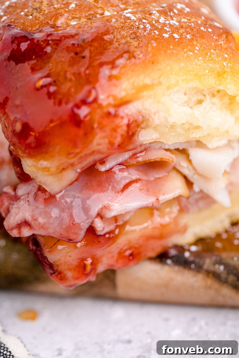 A close-up of a Monte Cristo sandwich with a dollop of fruit jam on top.