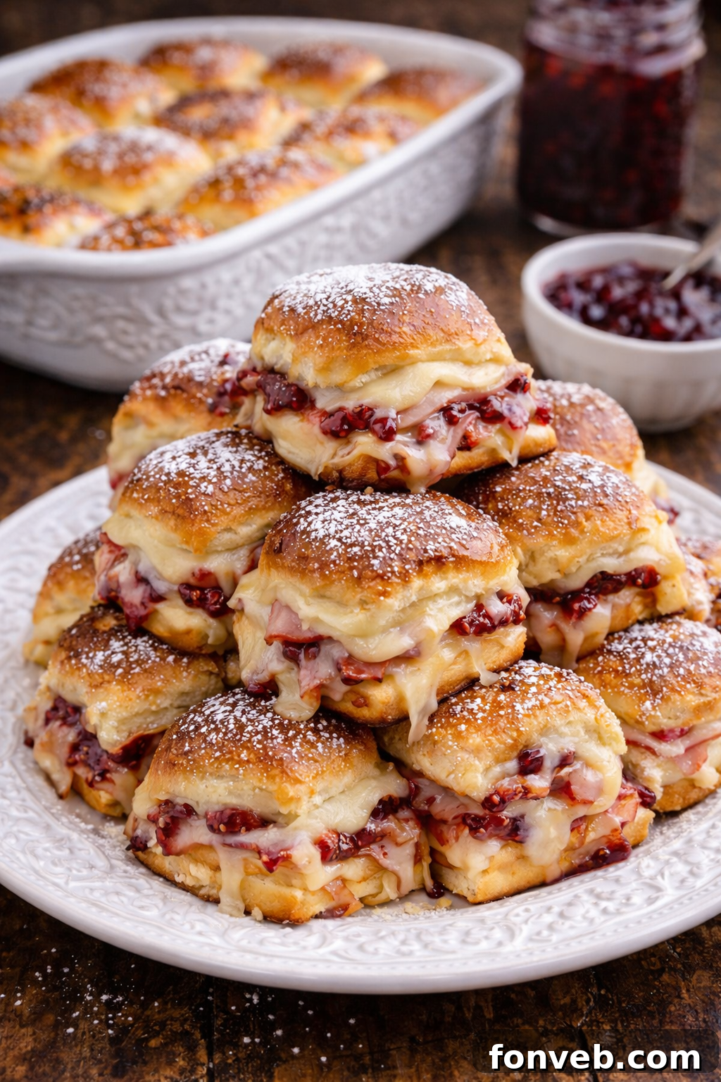 Monte Cristo Sliders stacked enticingly on a white plate, ready to be served.