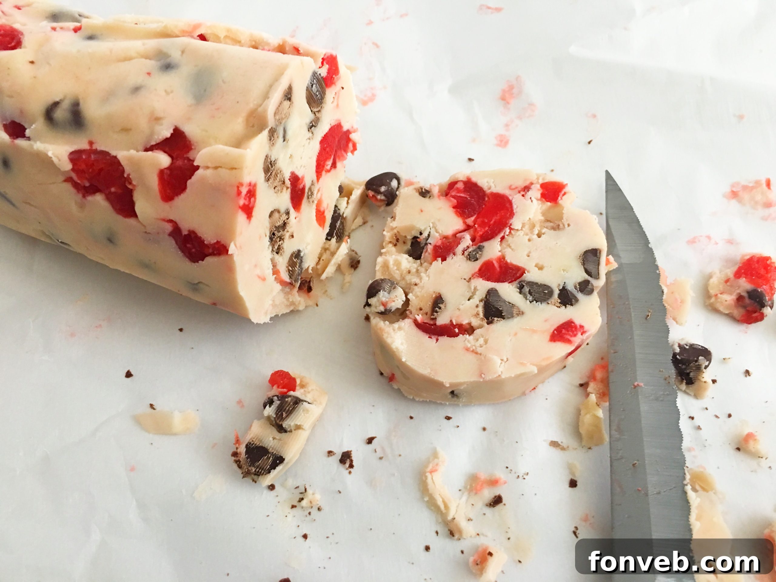 sliced cherry shortbread cookie dough on a cutting board