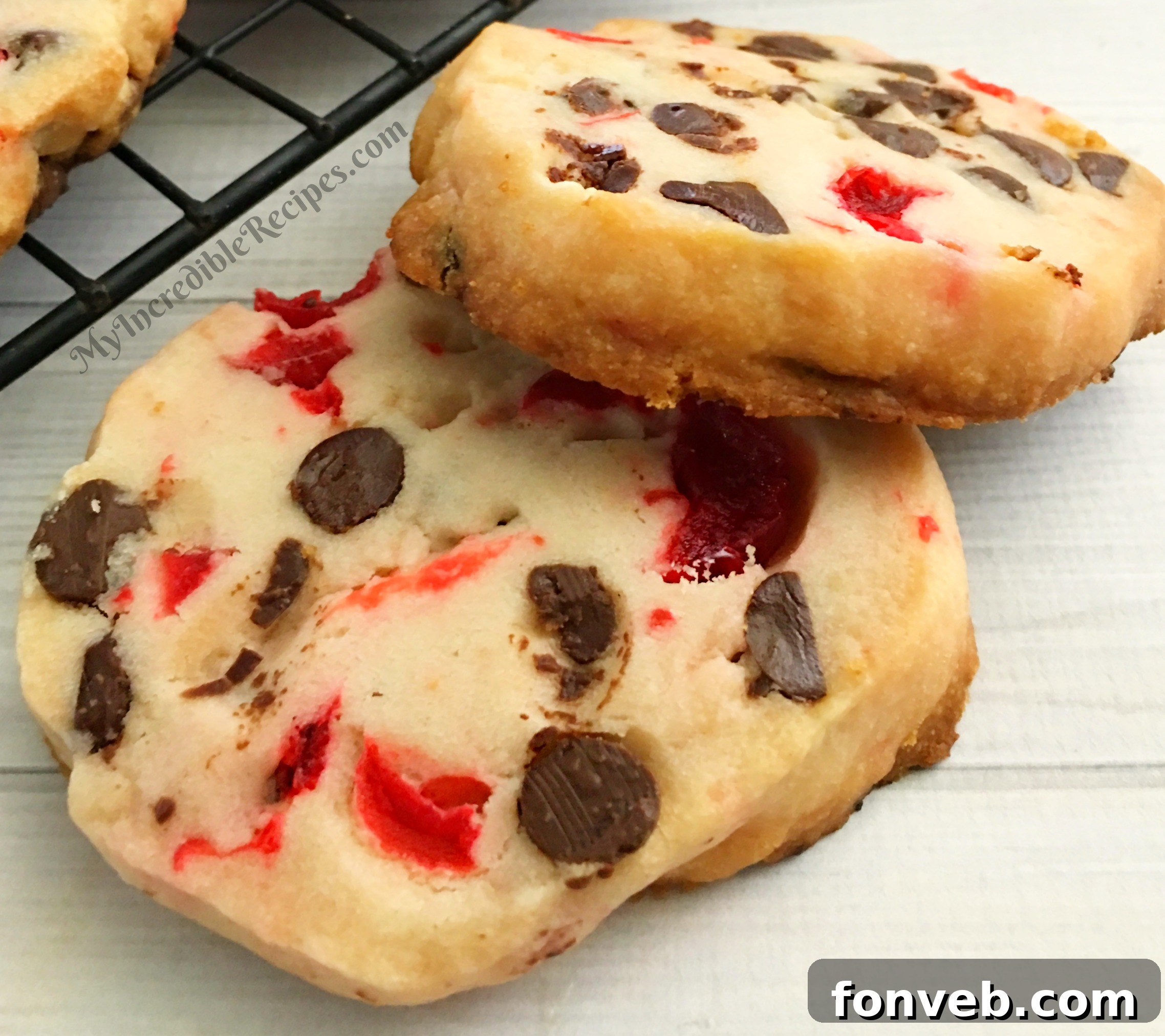 decorated cherry shortbread cookies on a cooling rack