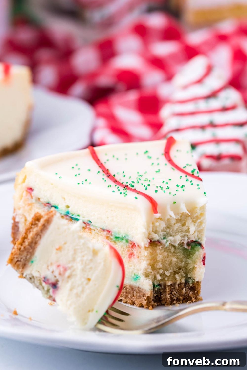 bite taken out of a slice of cheesecake on plate