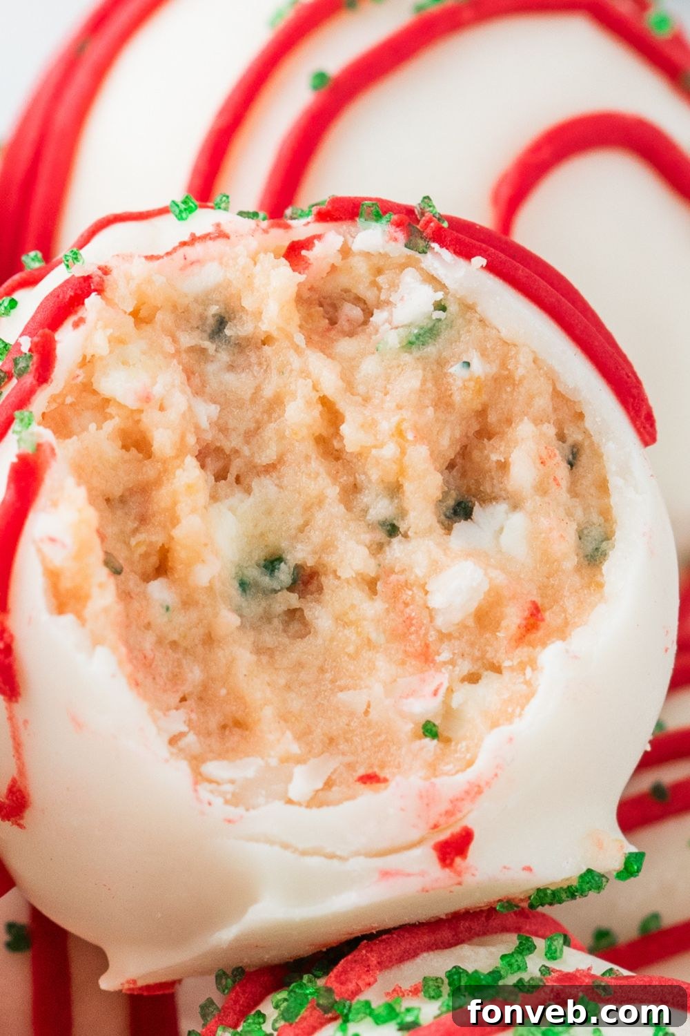 Little Debbie Christmas Tree Cake Truffles in a bowl with a bite taken out of one 
