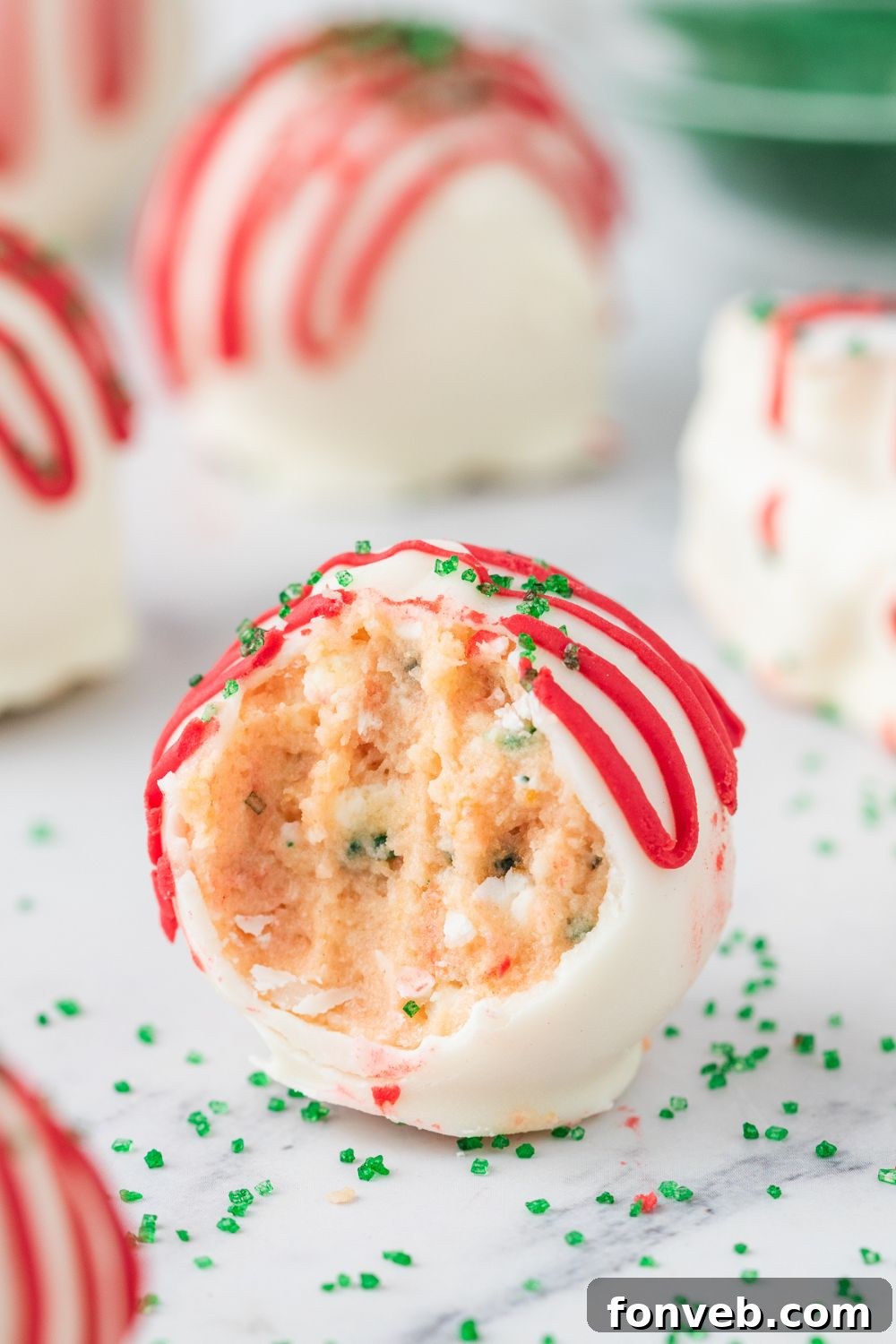 truffle with a bite taken out and sprinkles around it 