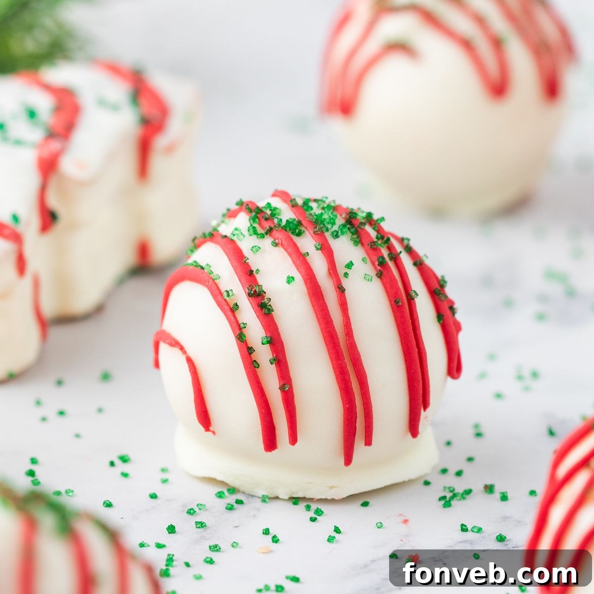 Little Debbie Christmas Tree Cake Truffles On table with a christmas tree cake behind it
