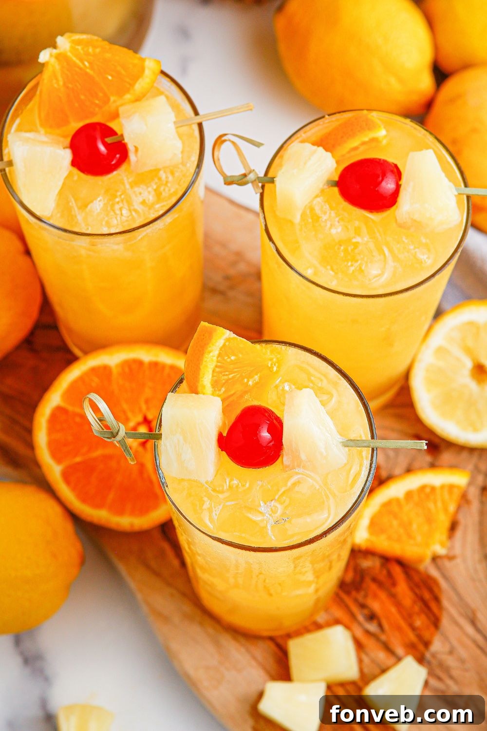 glasses with punch in them garnished with sliced fruit 