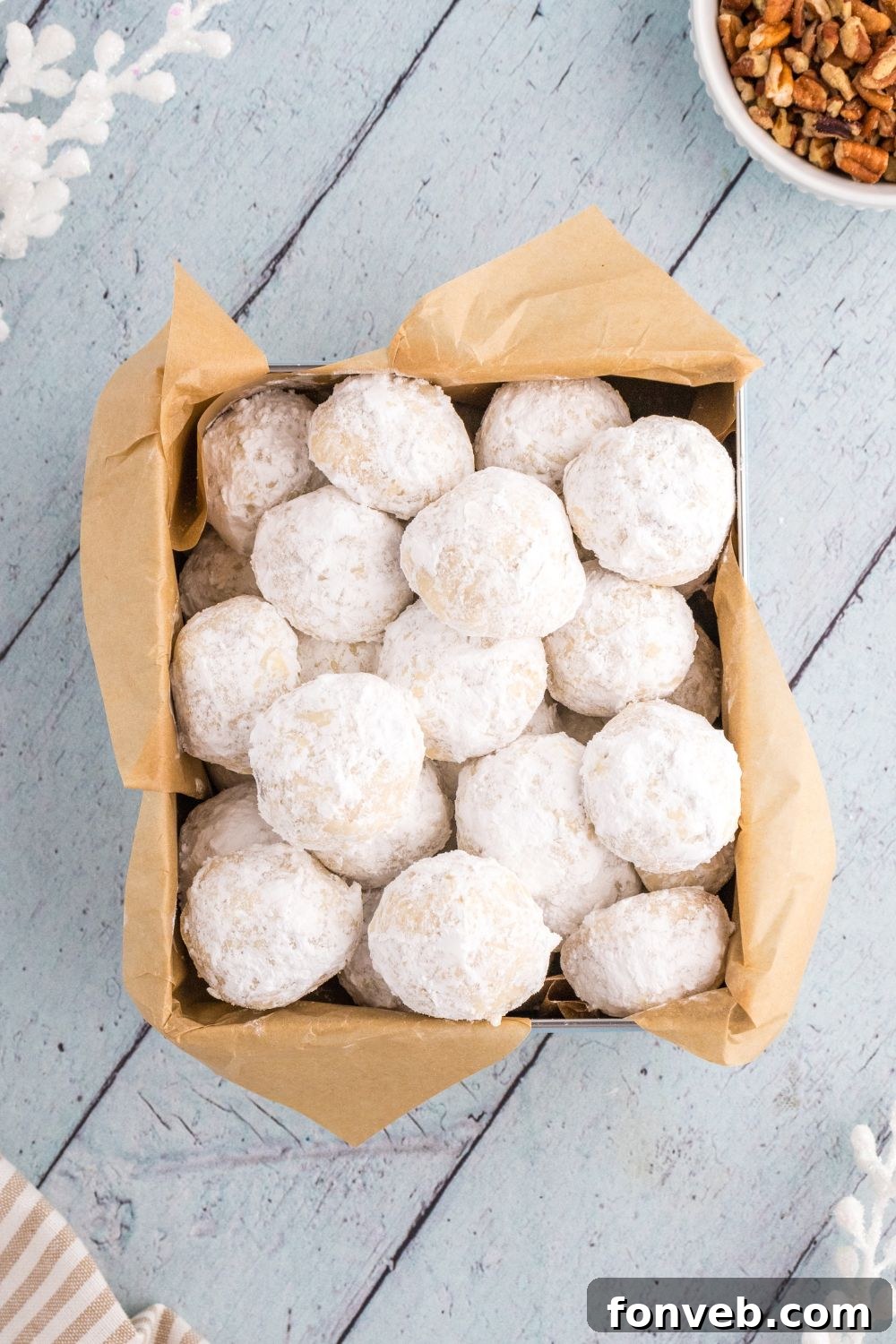 italian snowball cookies in a cookie box on table 