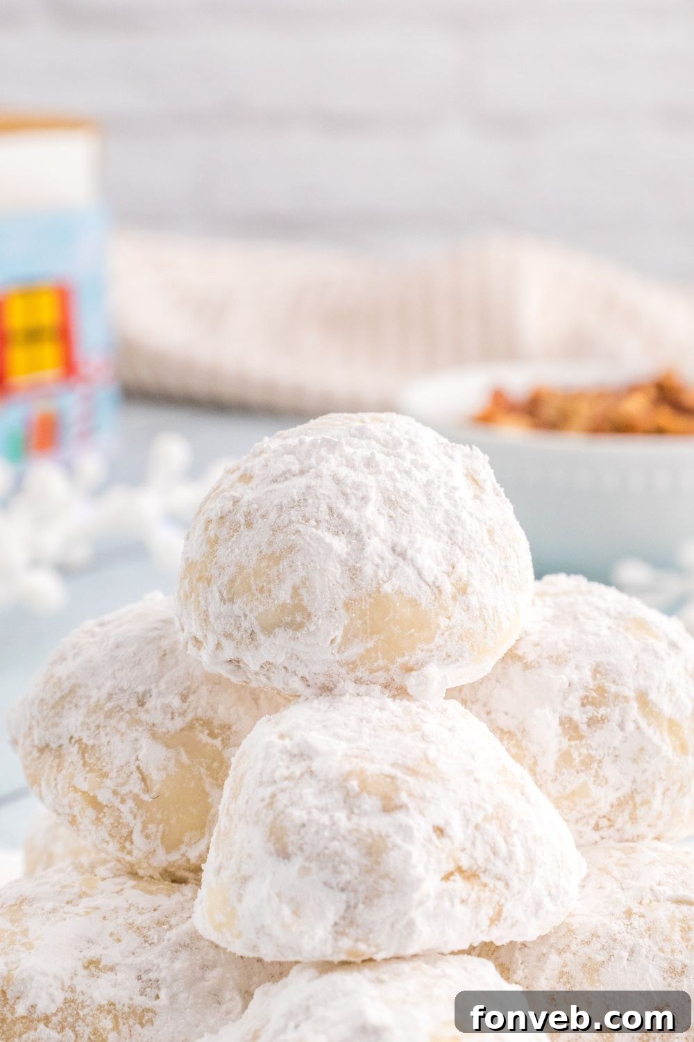 powdered cookies stacked on a tray 