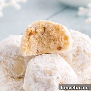Snowball Cookies on table with one that has a bite taken out of it