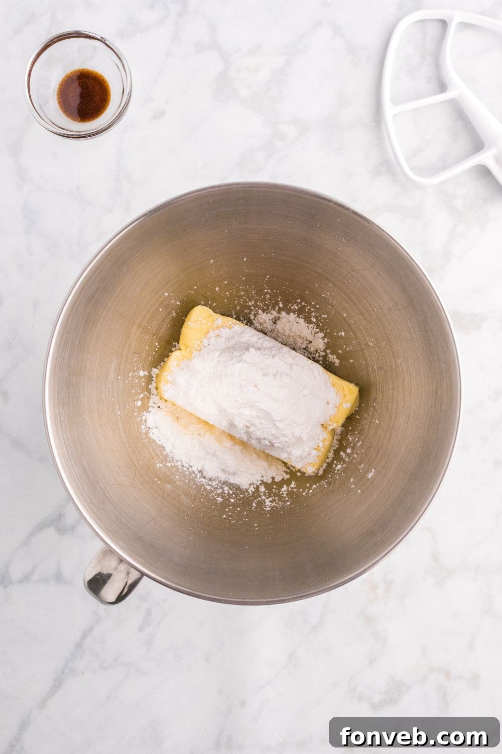 butter and powdered sugar in a mixing bowl 