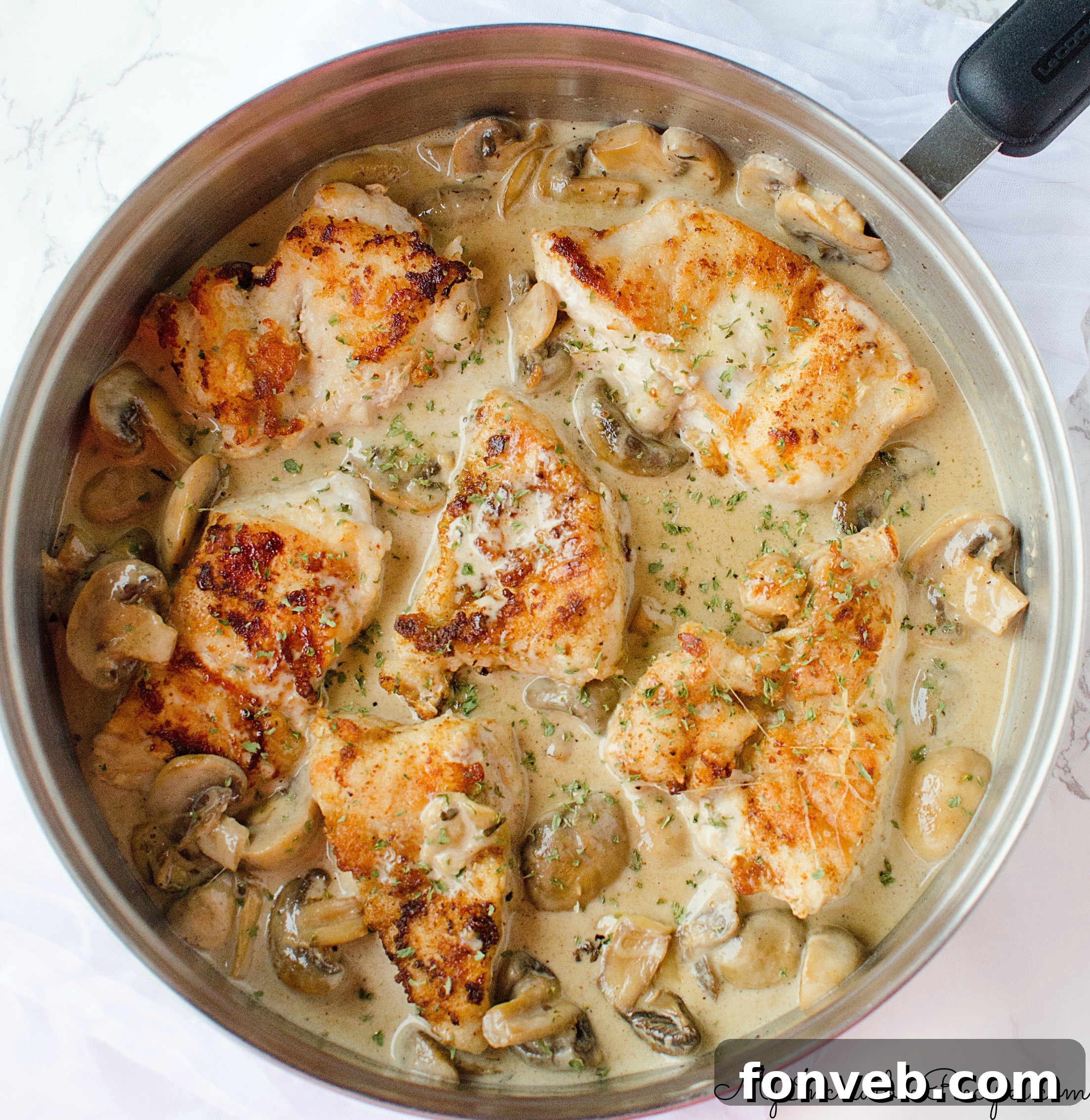 Golden brown chicken breast pieces with a rich Asiago cream sauce