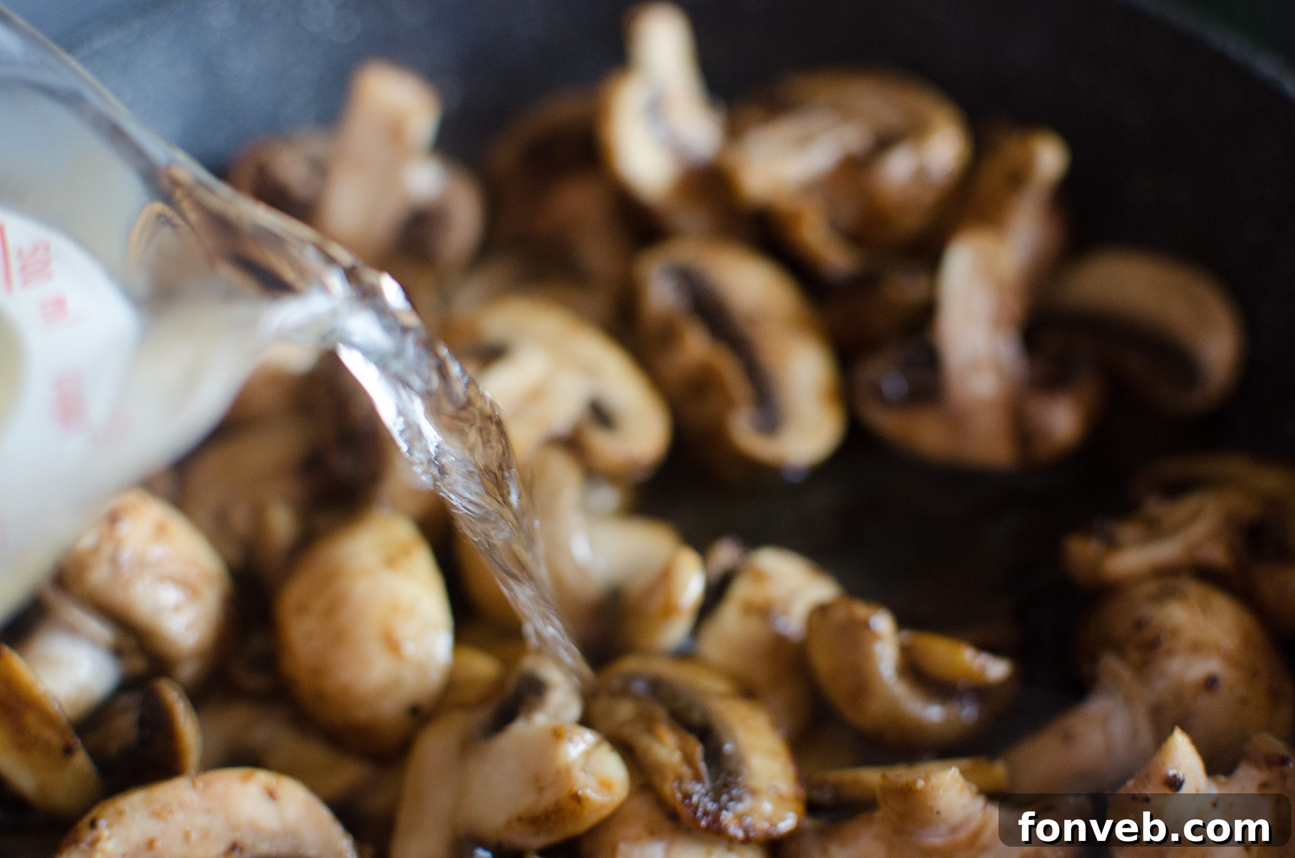 Creamy Asiago chicken served in a skillet, showcasing the rich sauce and mushrooms