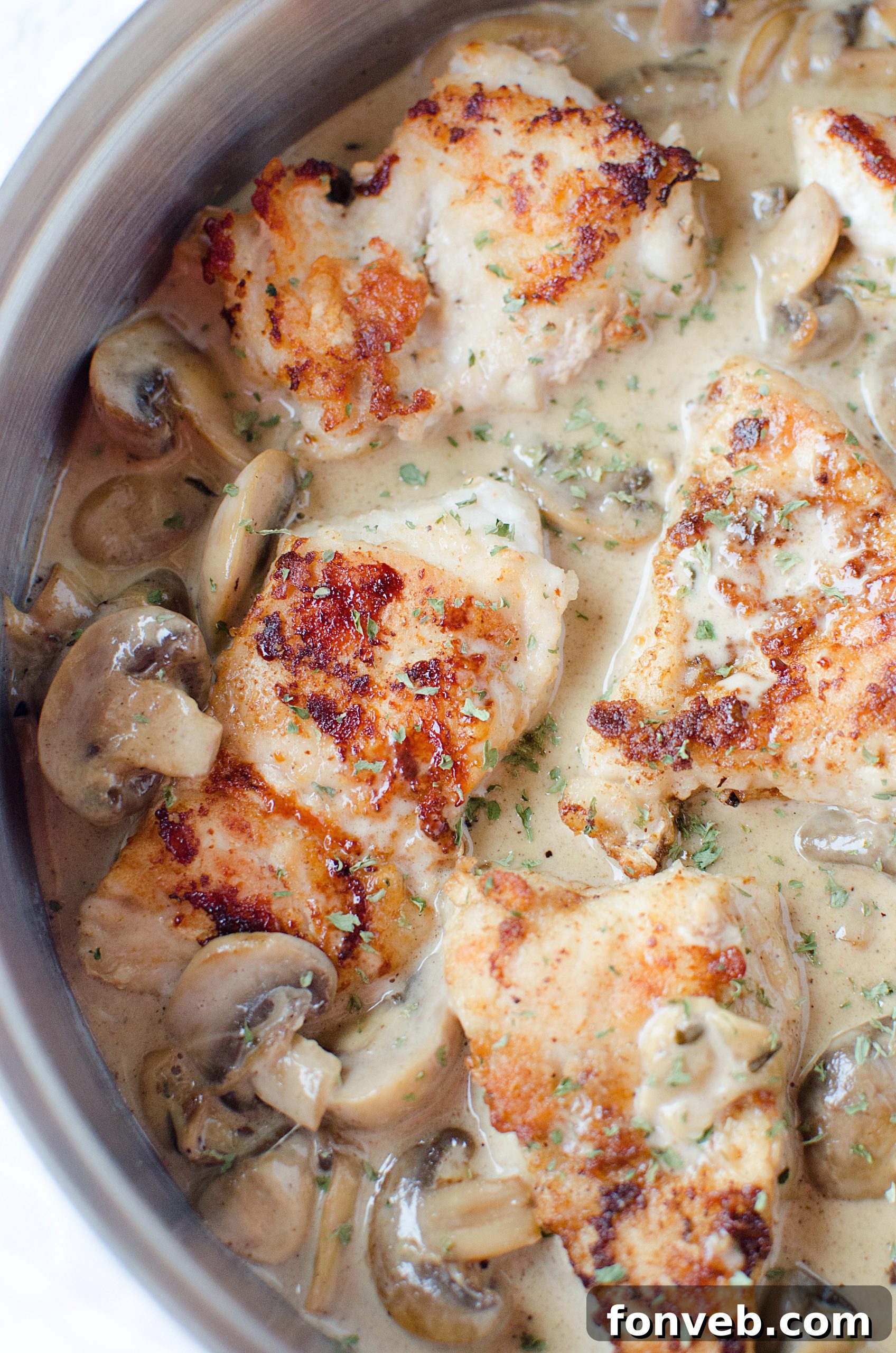 Shredded Asiago cheese ready to be added to the creamy sauce