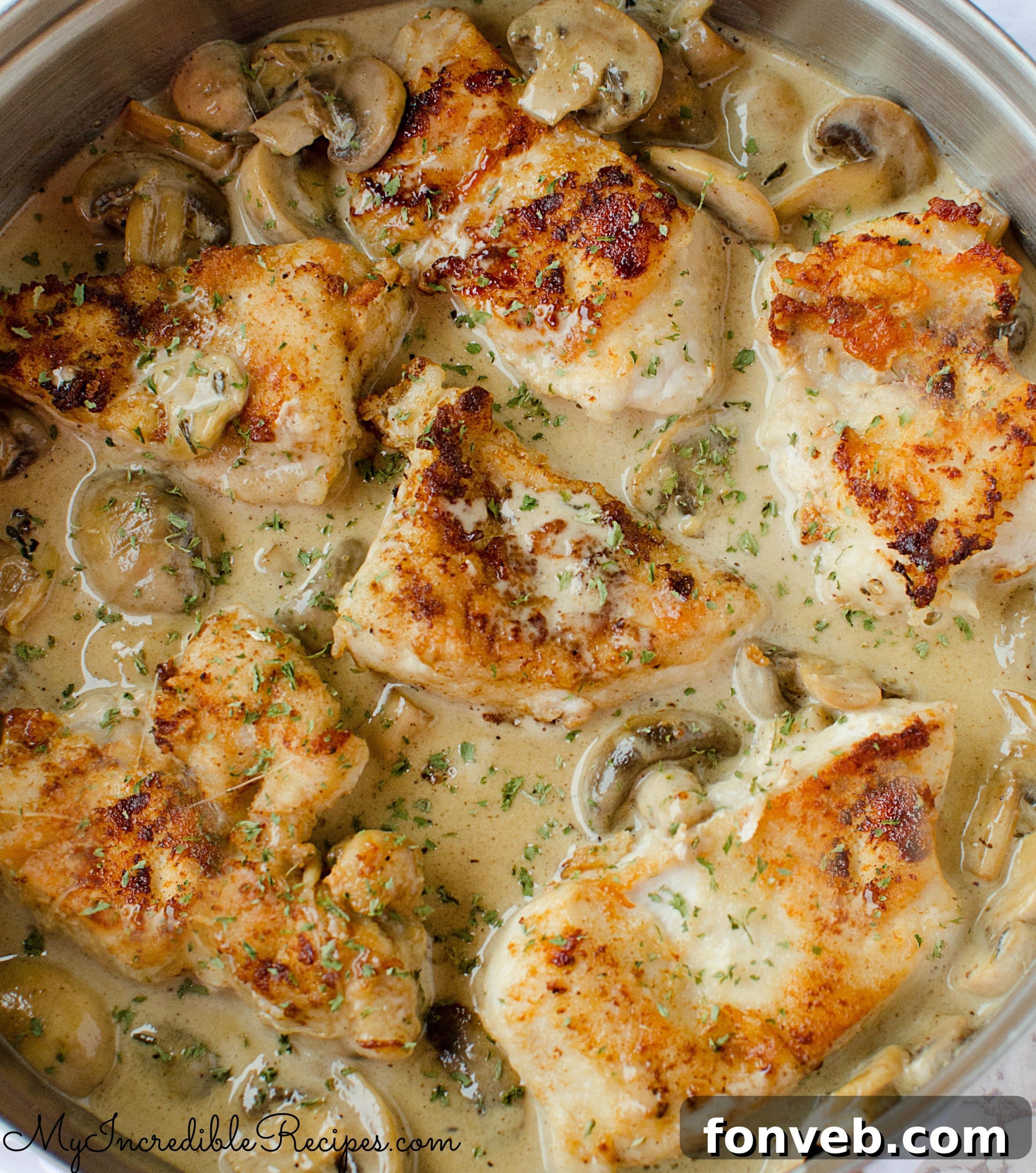 Close-up of the tender chicken pieces coated in the creamy Asiago sauce