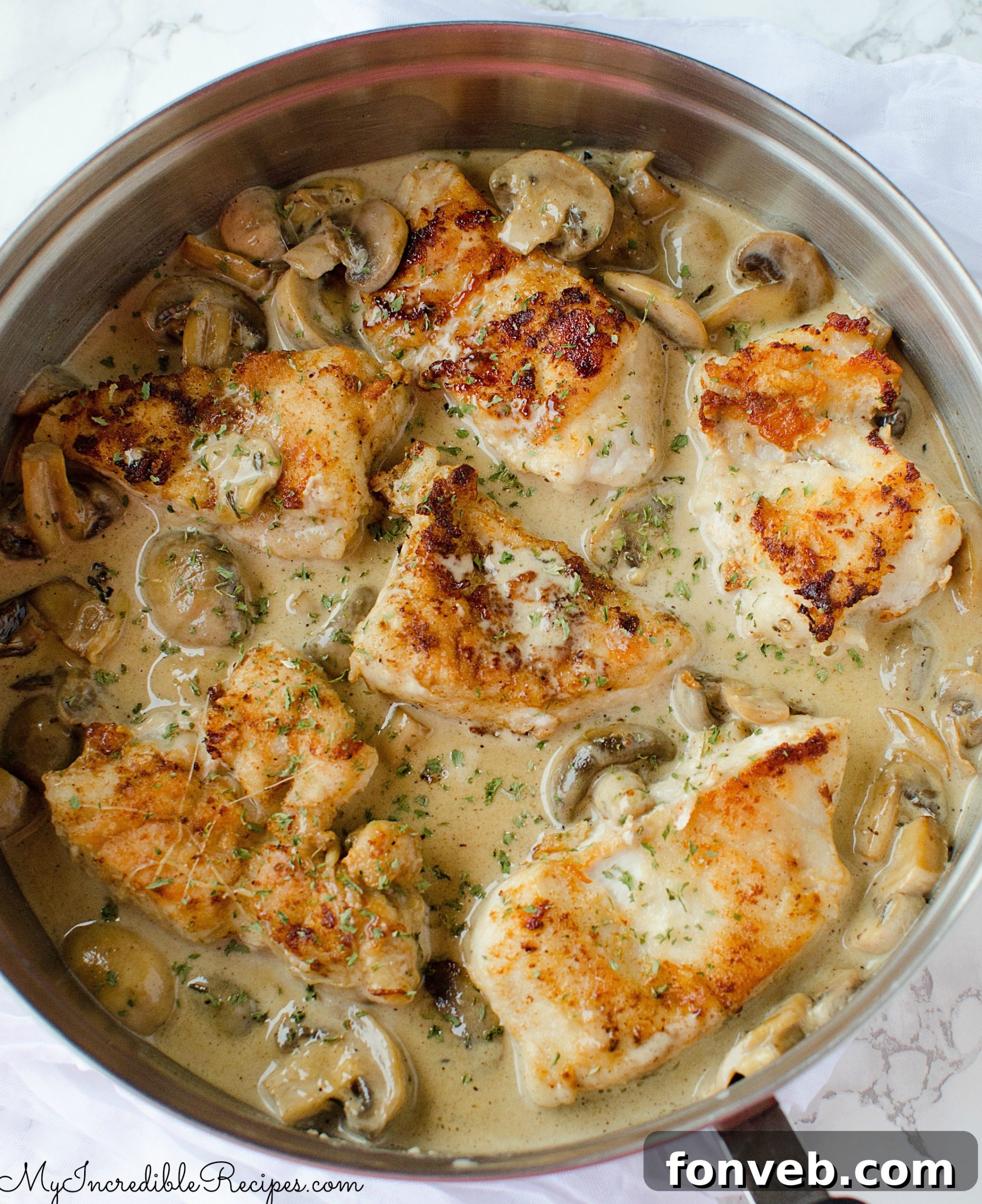 Full plate of Creamy Asiago chicken, garnished with fresh parsley